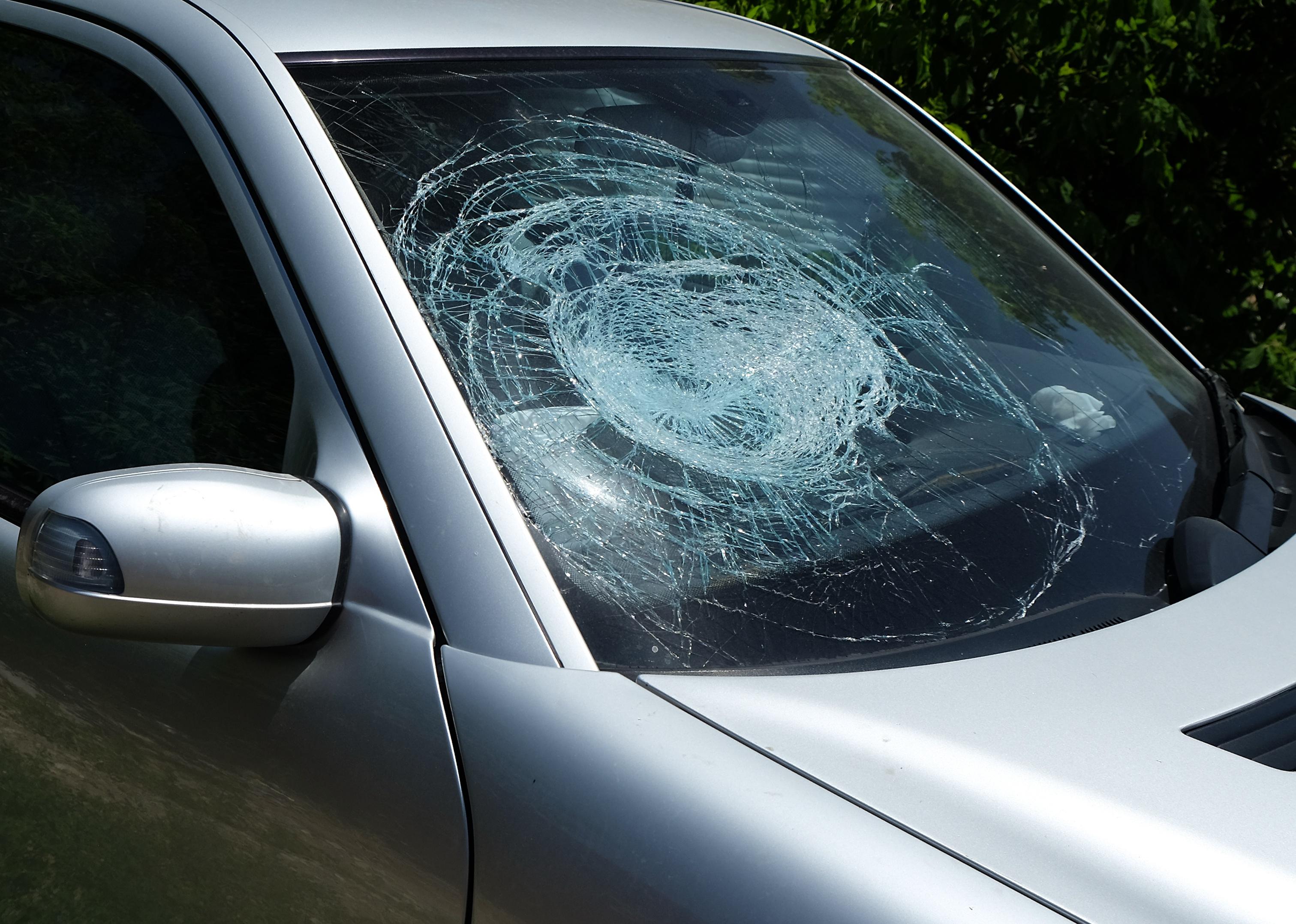 Shattered front windshield on the right passenger side of a car