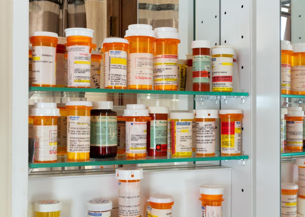 A medicine cabinet full of prescription drug bottles.