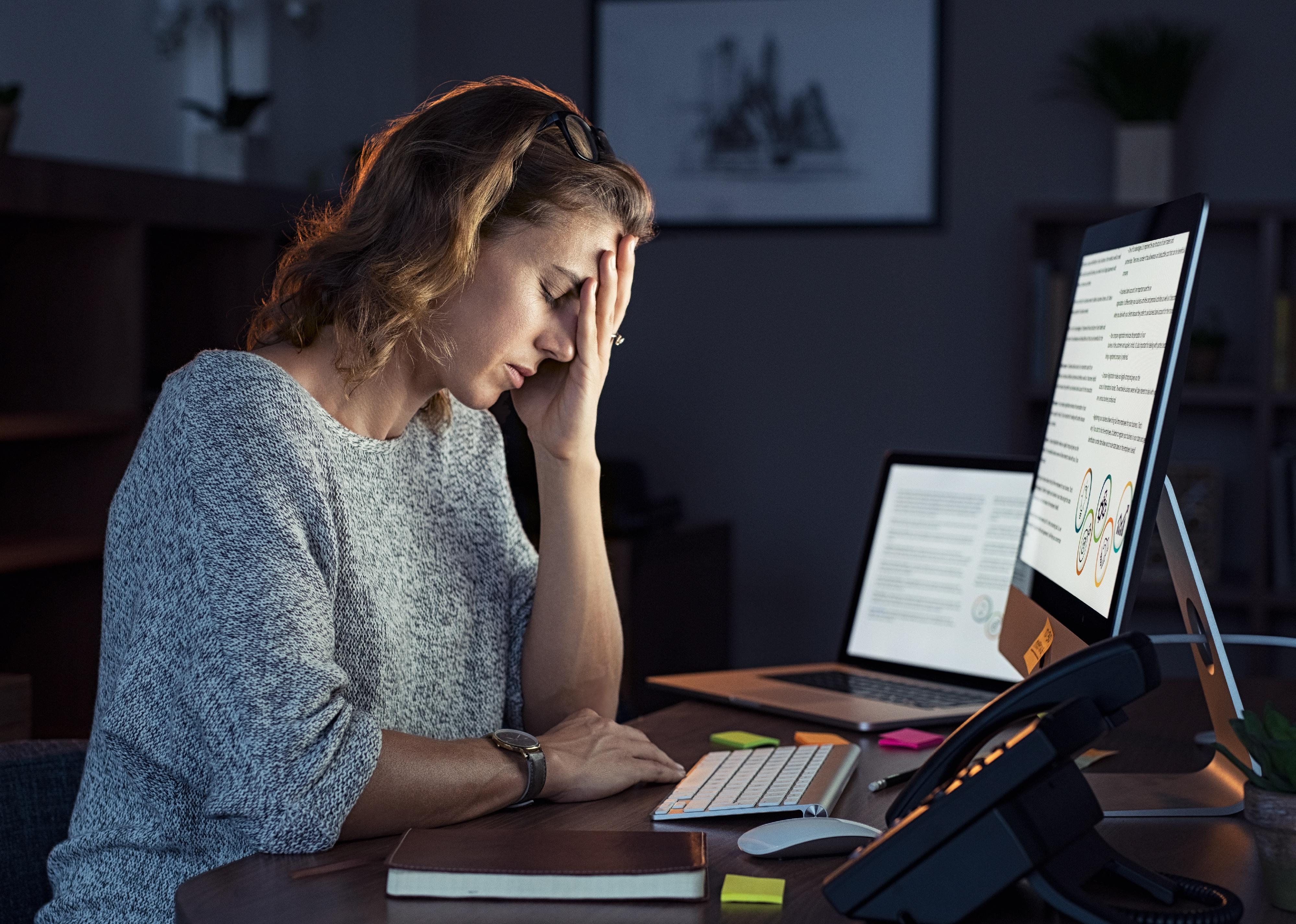 Businesswoman working on computer at night.