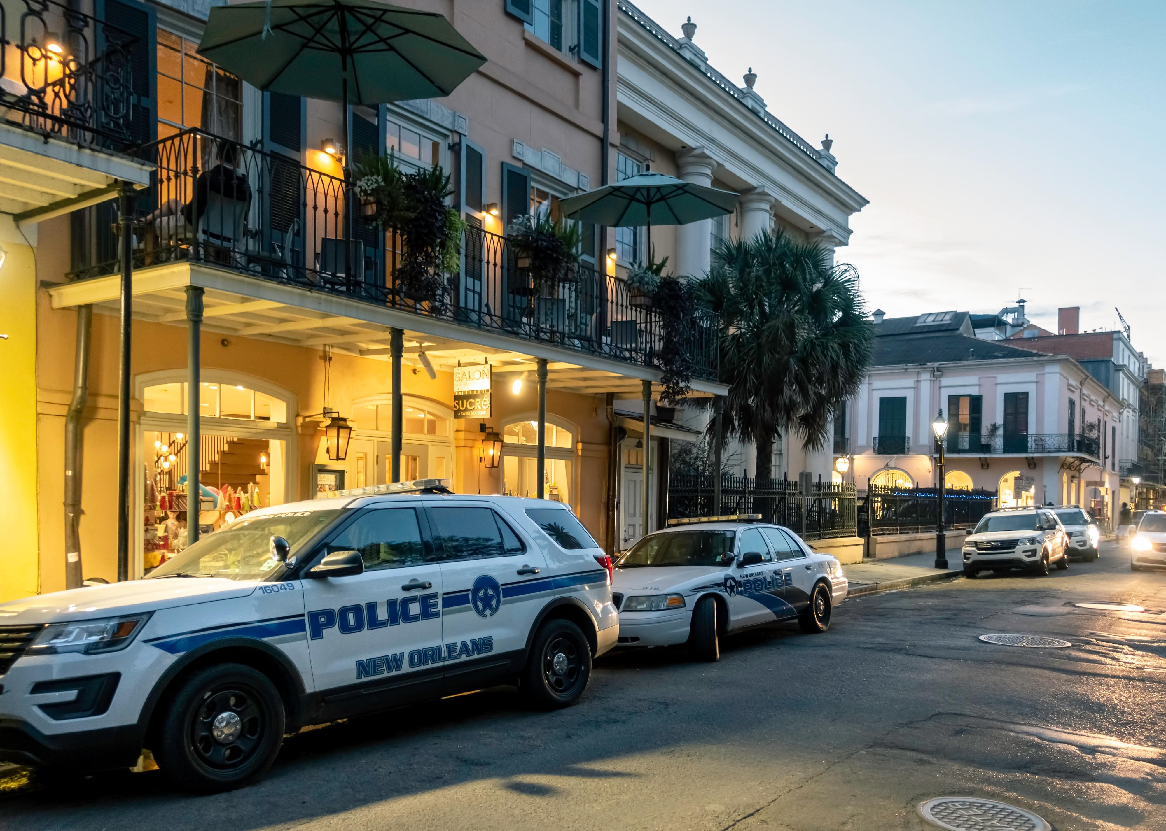 Police vehicles parked in the iconic French Quarter. 