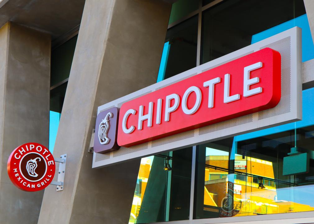 A close up of a Chipotle sign attached to a building. 