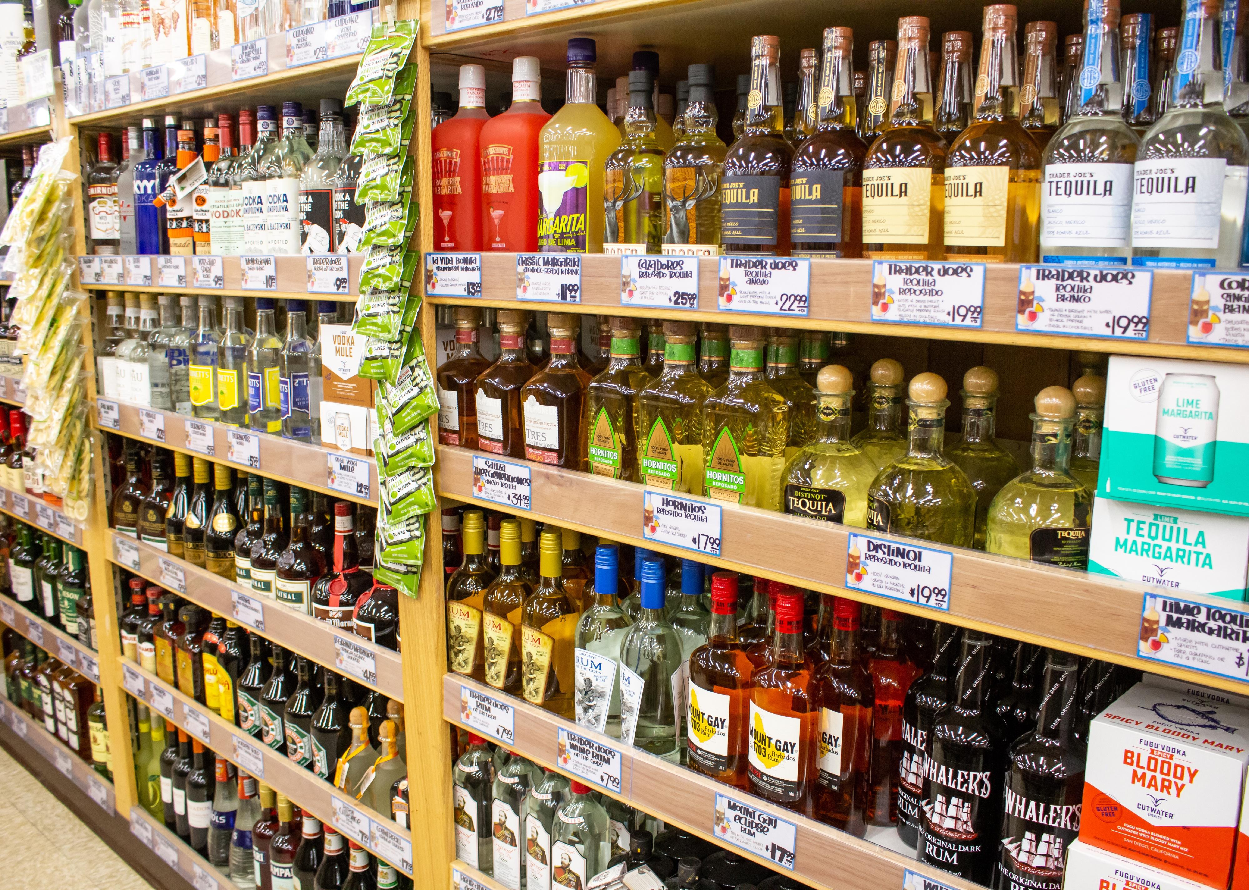 Aisle of liquor bottles in a store.