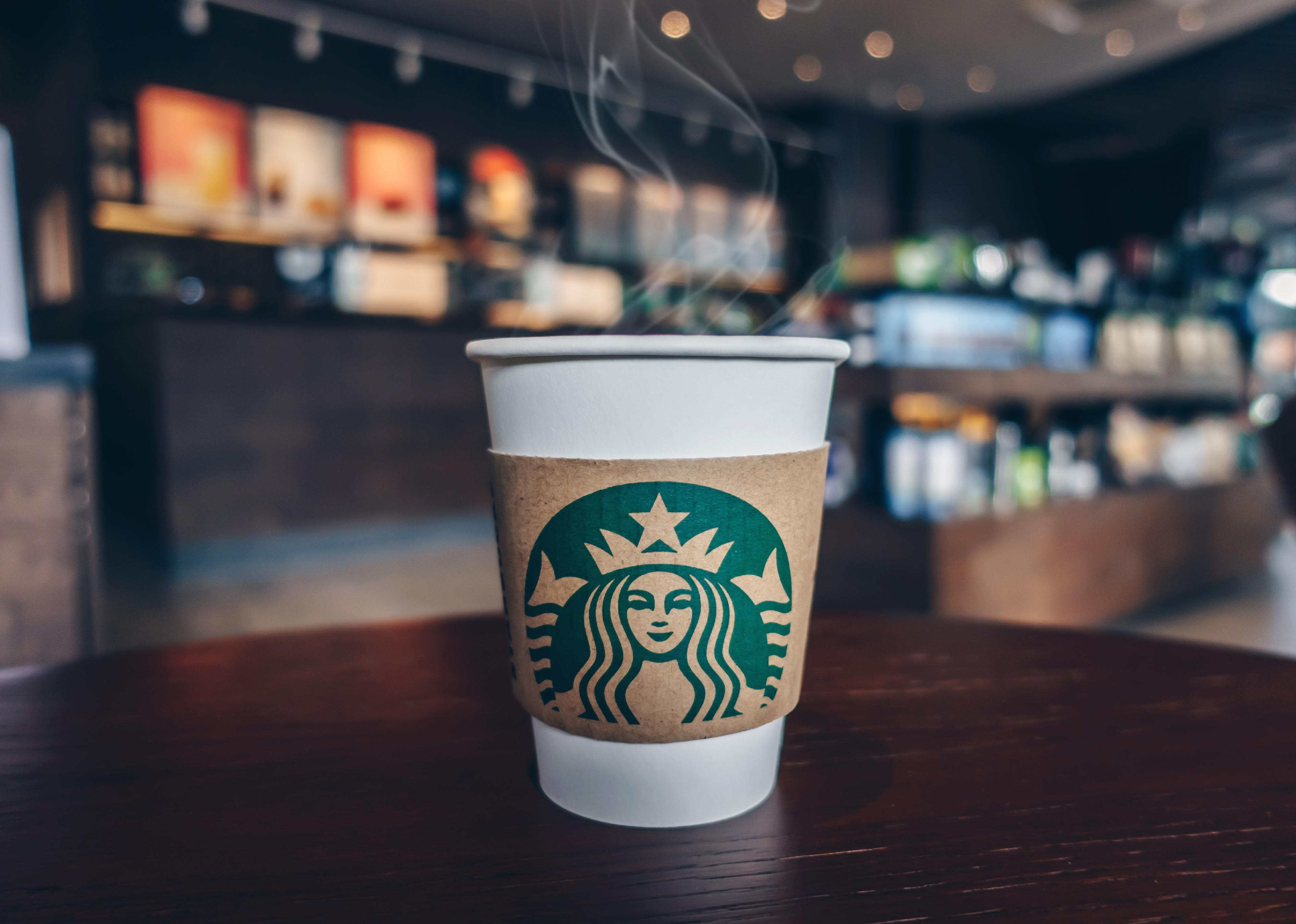 Starbucks cup on brown table.