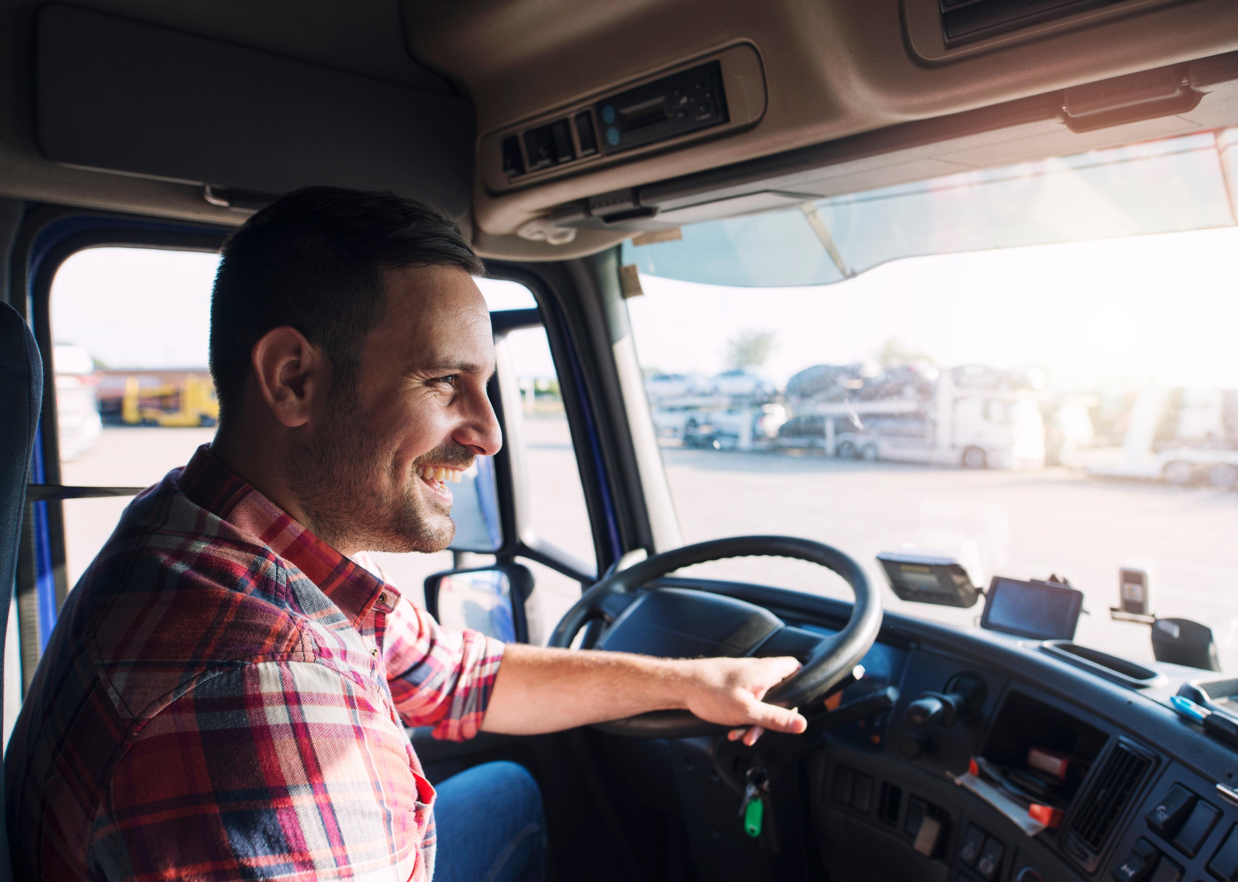 Truck driver in casual clothes driving truck