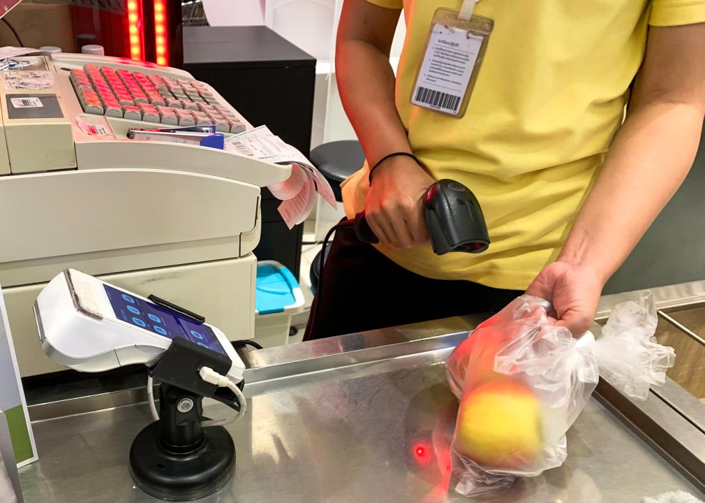 Female scanning product barcode in a supermarket