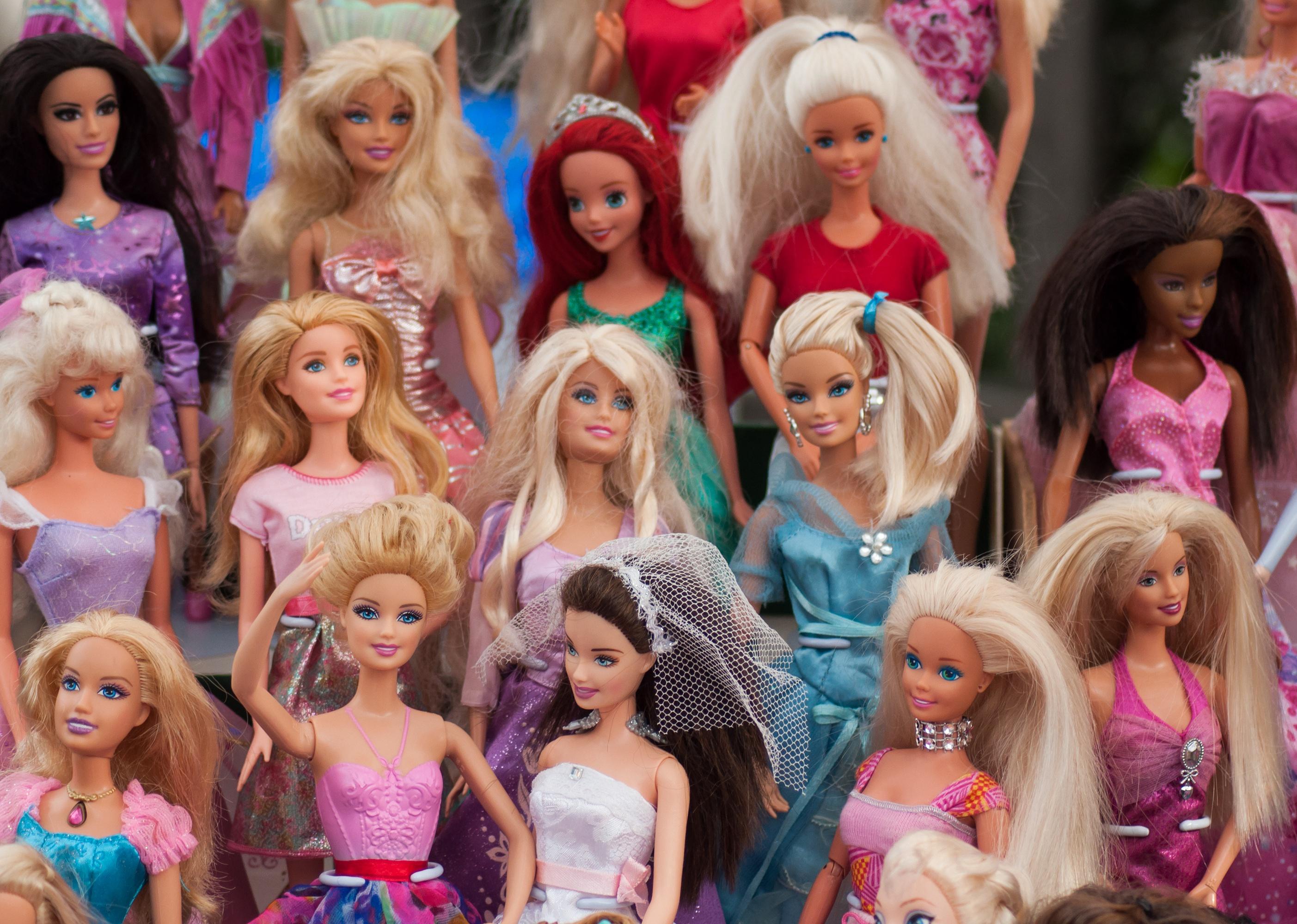 Close-up of Barbie dolls on display.
