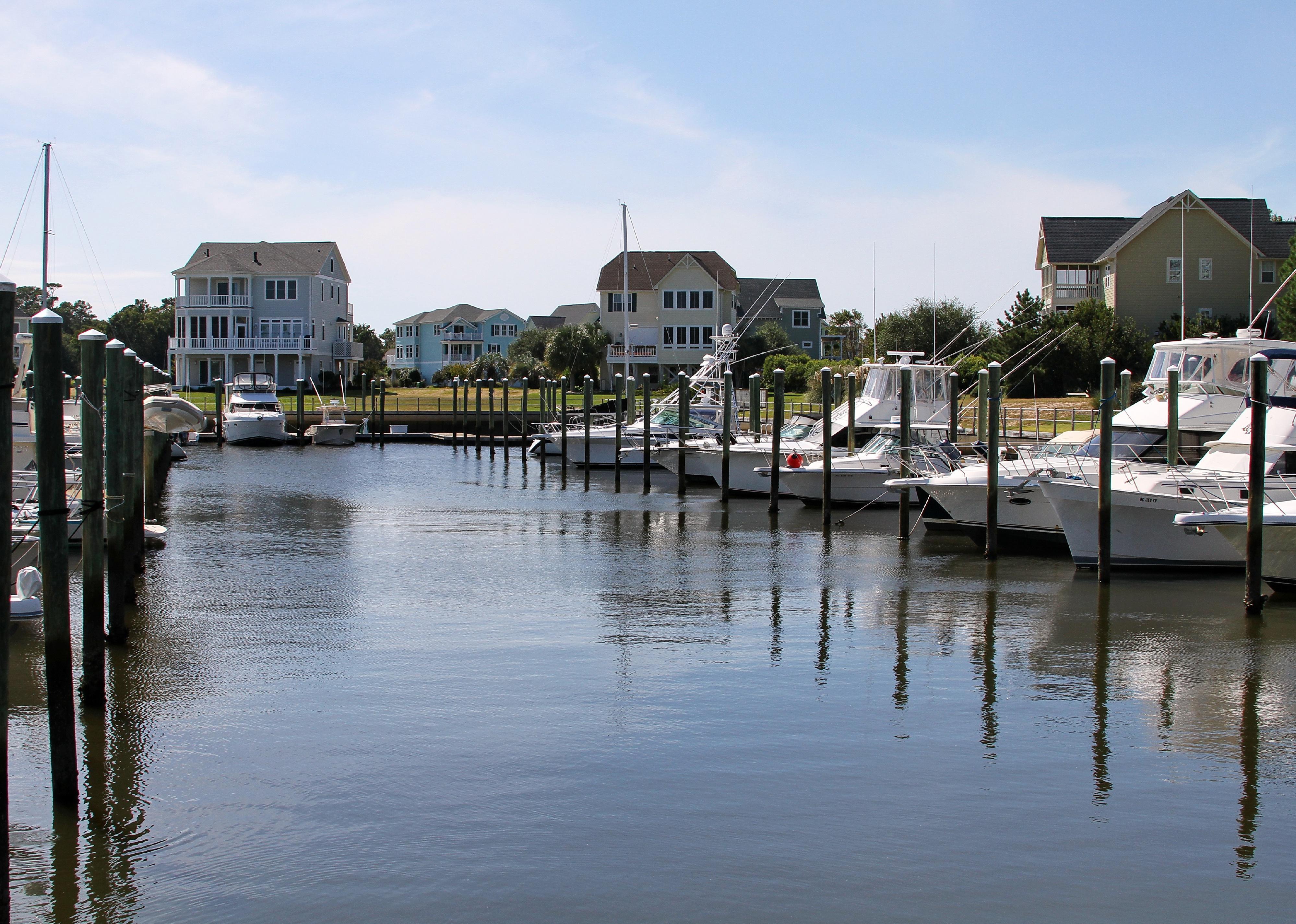 Waterfront homes by marina in summer.