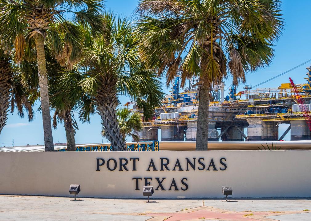 Port Aransas sign and cargo in background.