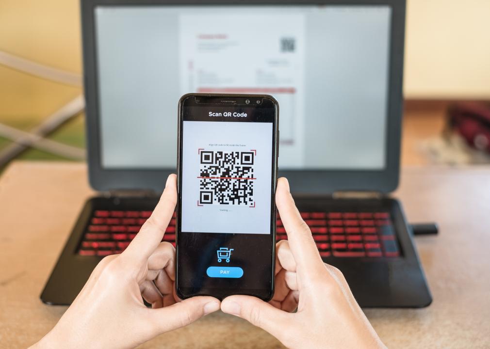 Closeup of smartphone making mobile payment via QR code.