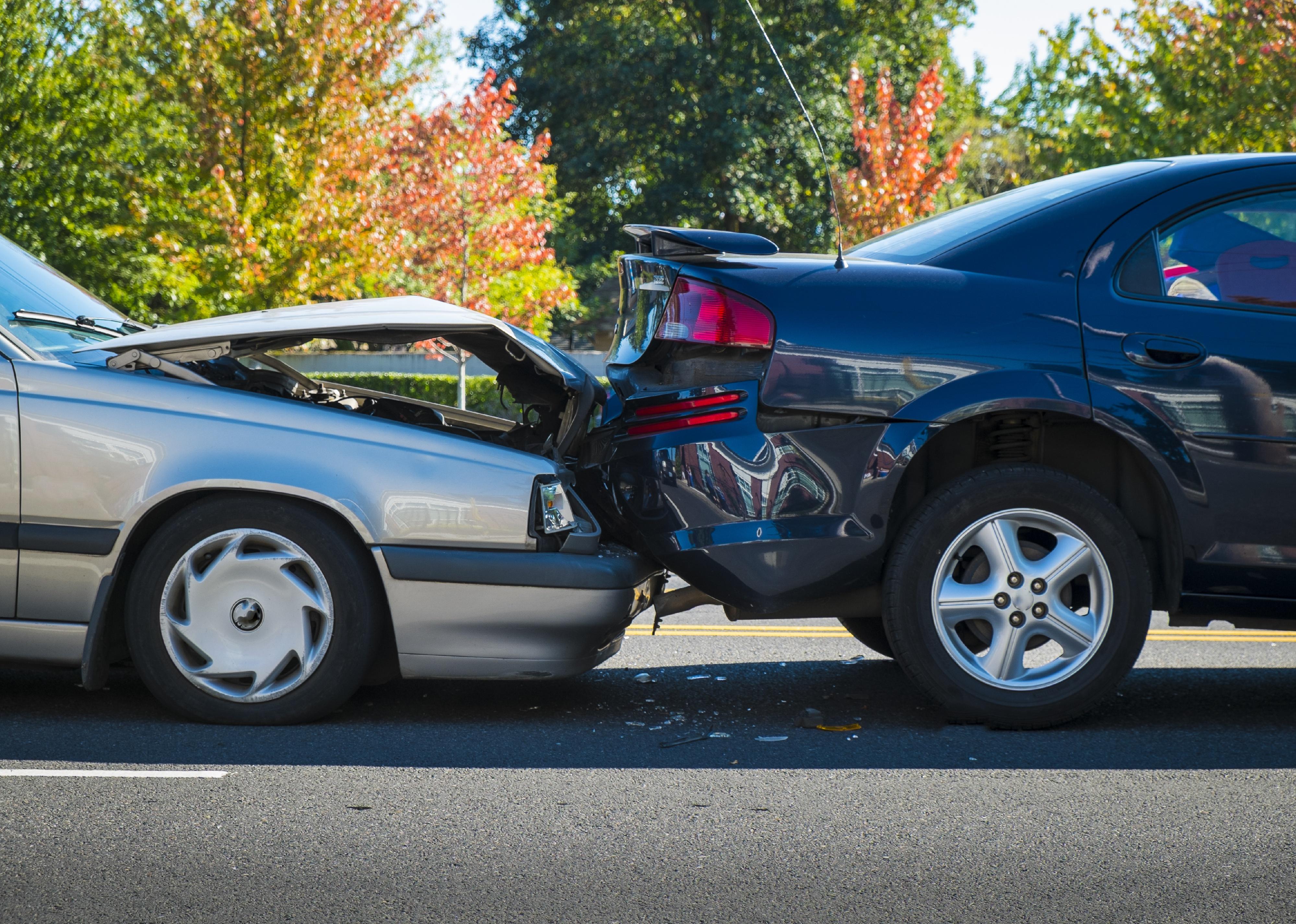 Auto accident involving two cars on a city street.