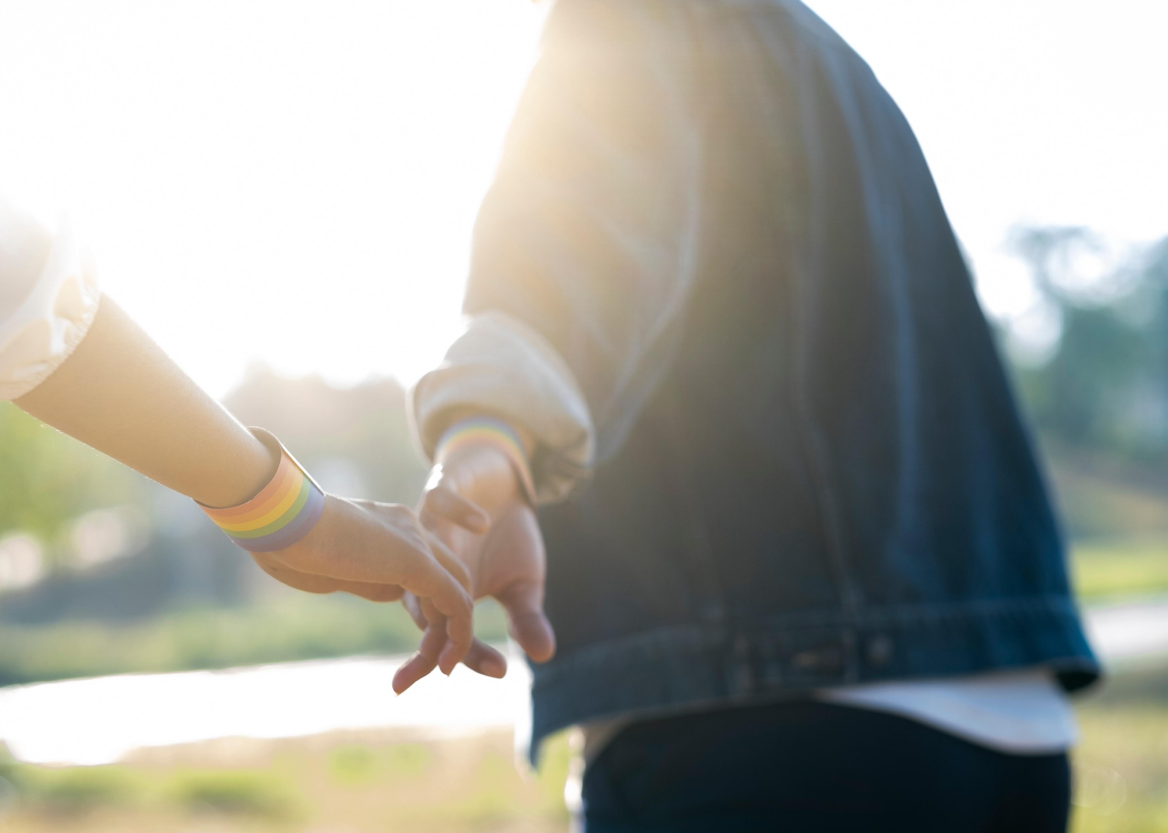 Close-up hands of LGBTQ+ couple.