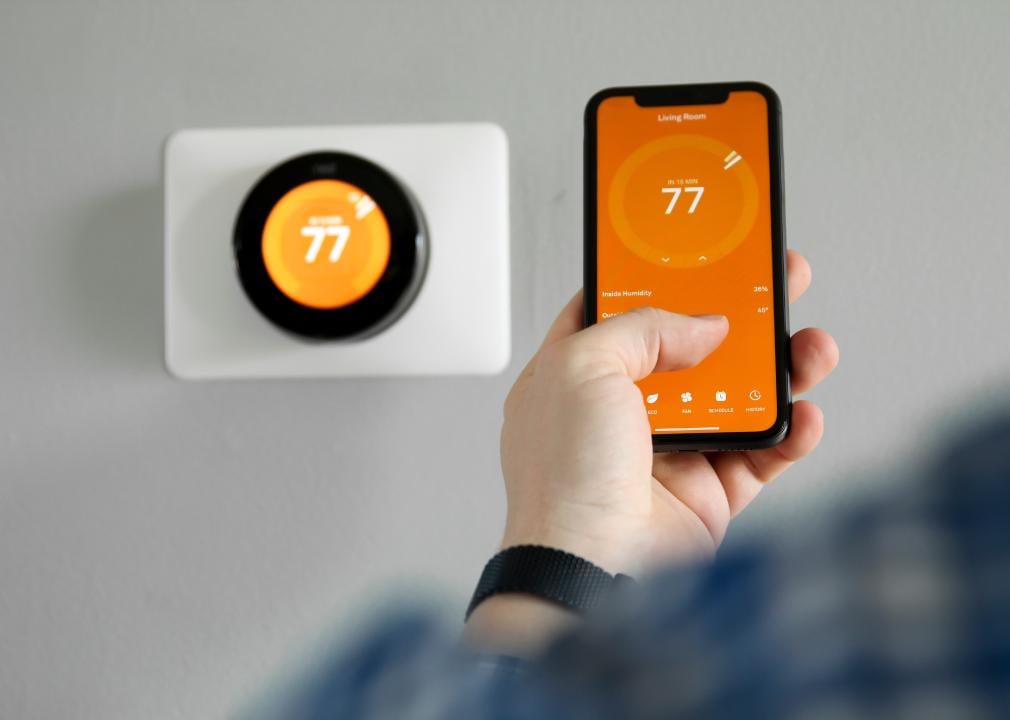 Man uses a smart home app tocontrol temperatures