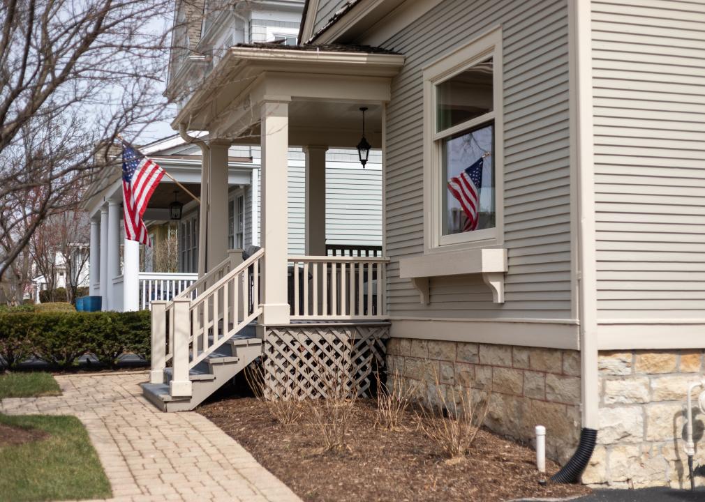 An American flag reflecting in window of home.