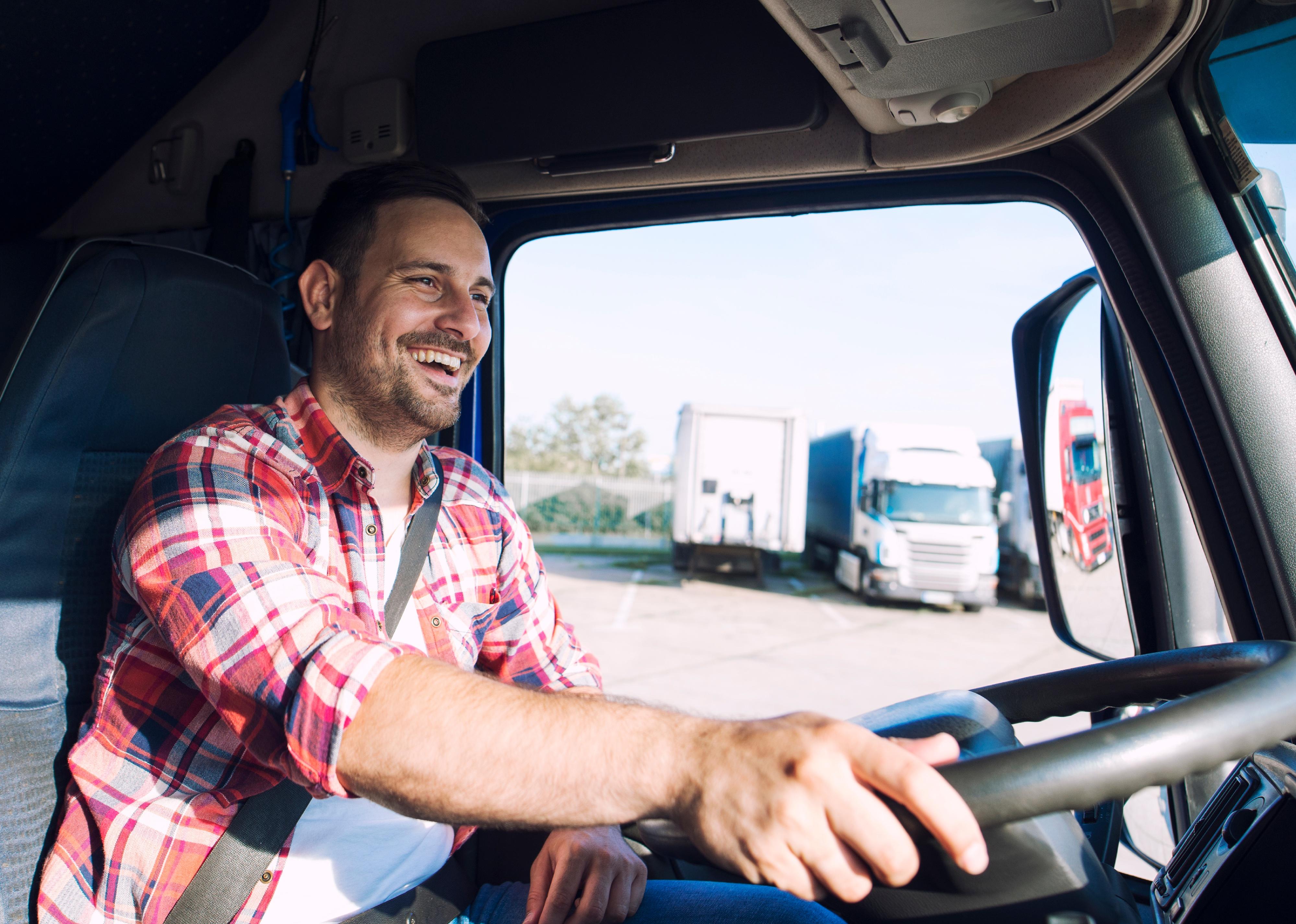 Truck driver in casual clothes driving truck.