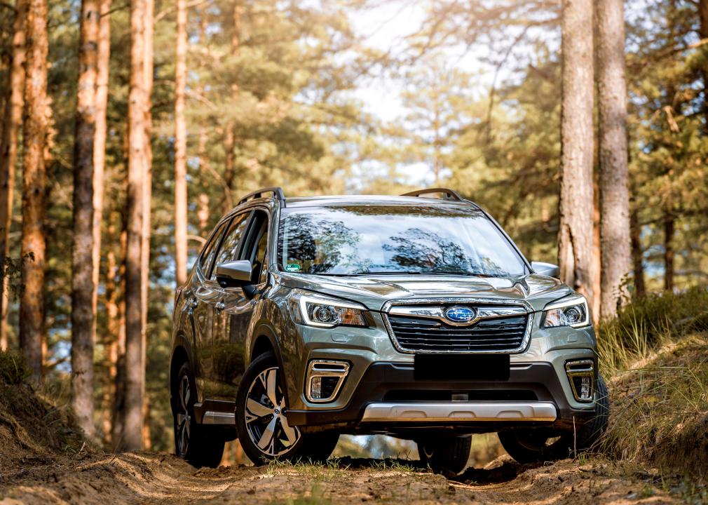 Subaru Forester e-Boxer outdoors on a dirt road surrounded by tall trees.