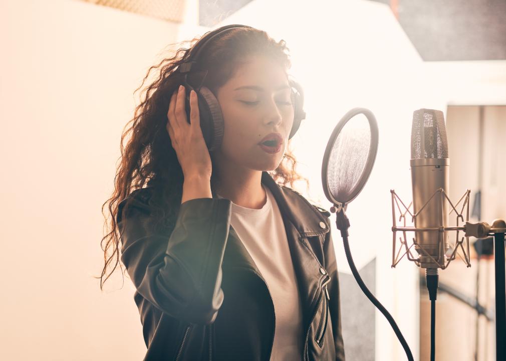 Female singer recording in music studio