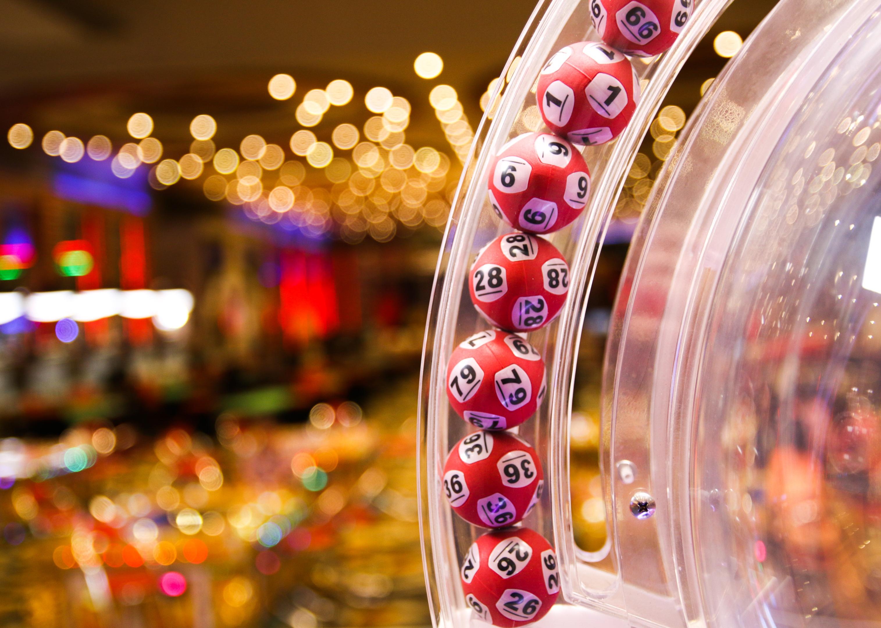 Red lottery balls in a bingo machine.