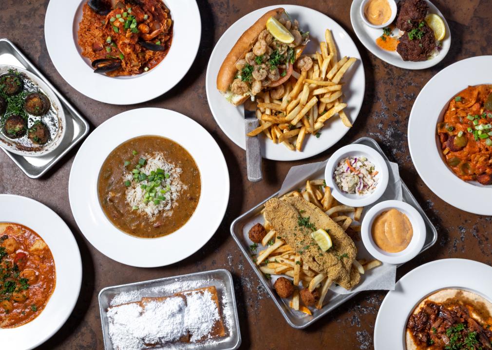 An overhead view of a table full of cajun creole dishes.