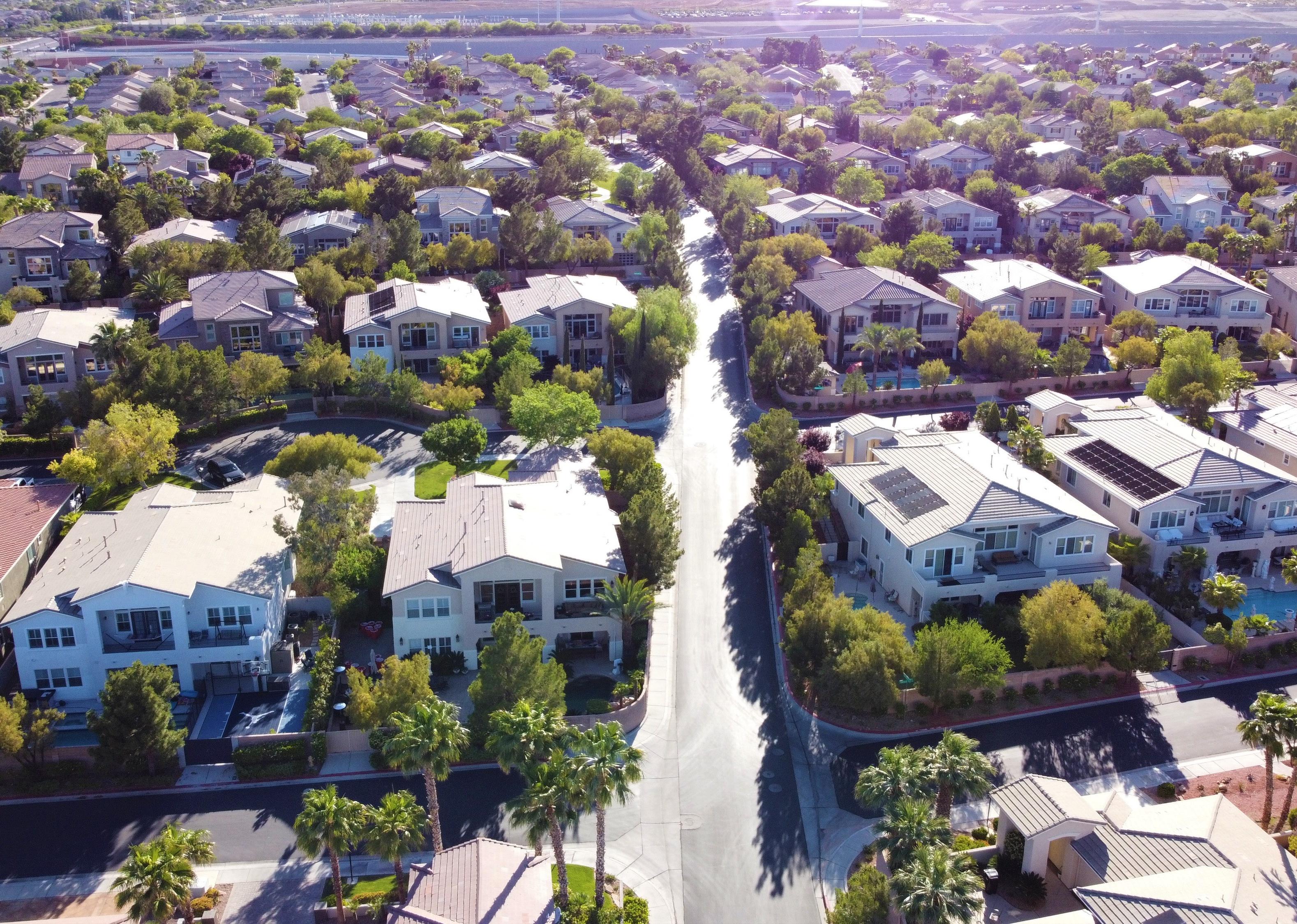 Aerial view of suburban neighborhood road during late afternoon in Las Vegas.