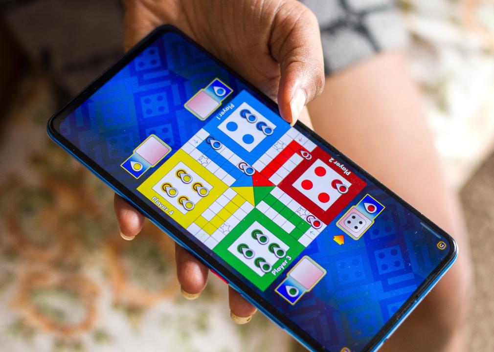 Ludo King mobile app shown on phone.