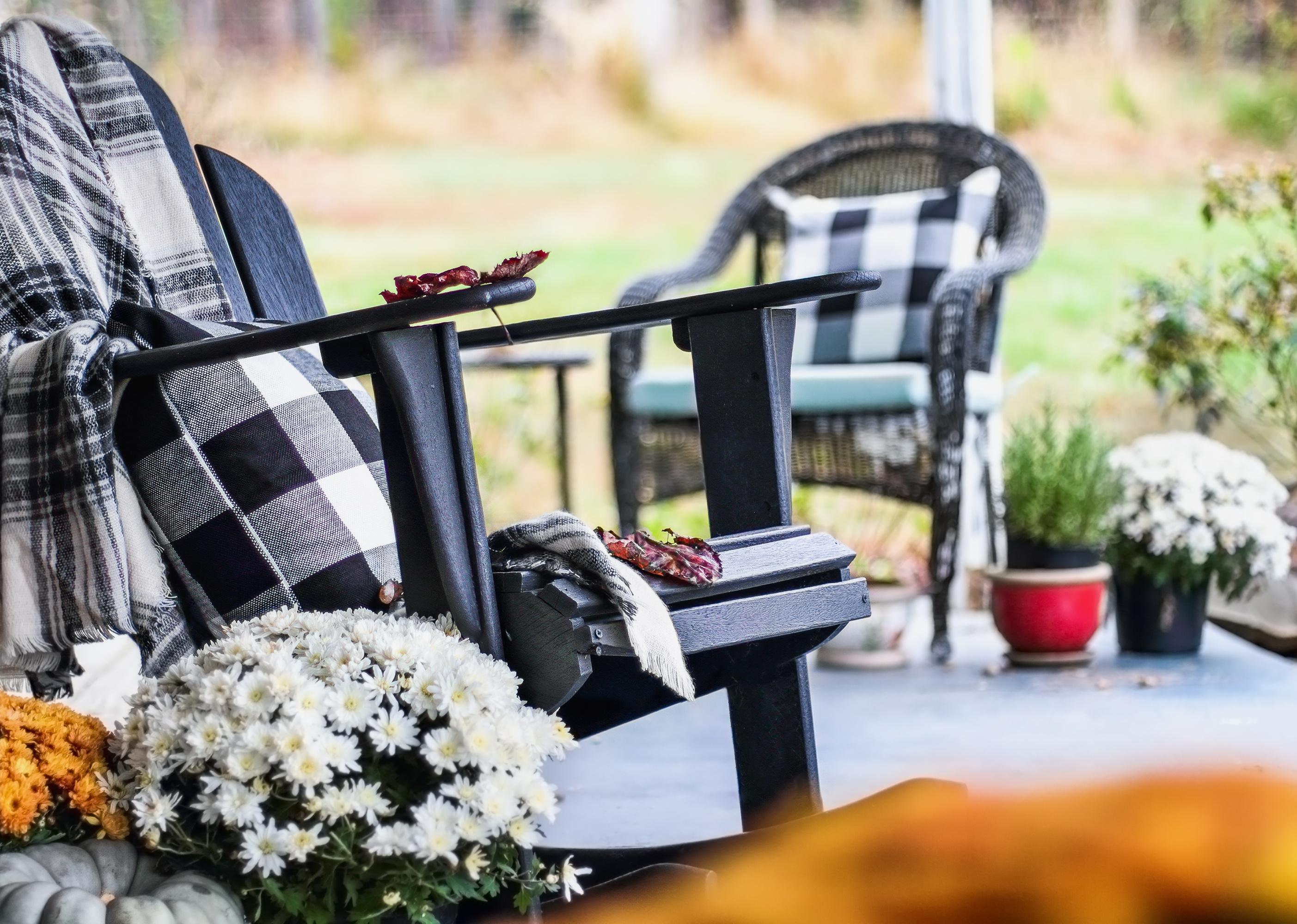 Adirondack rocking chair with style buffalo check blanket and pillows.