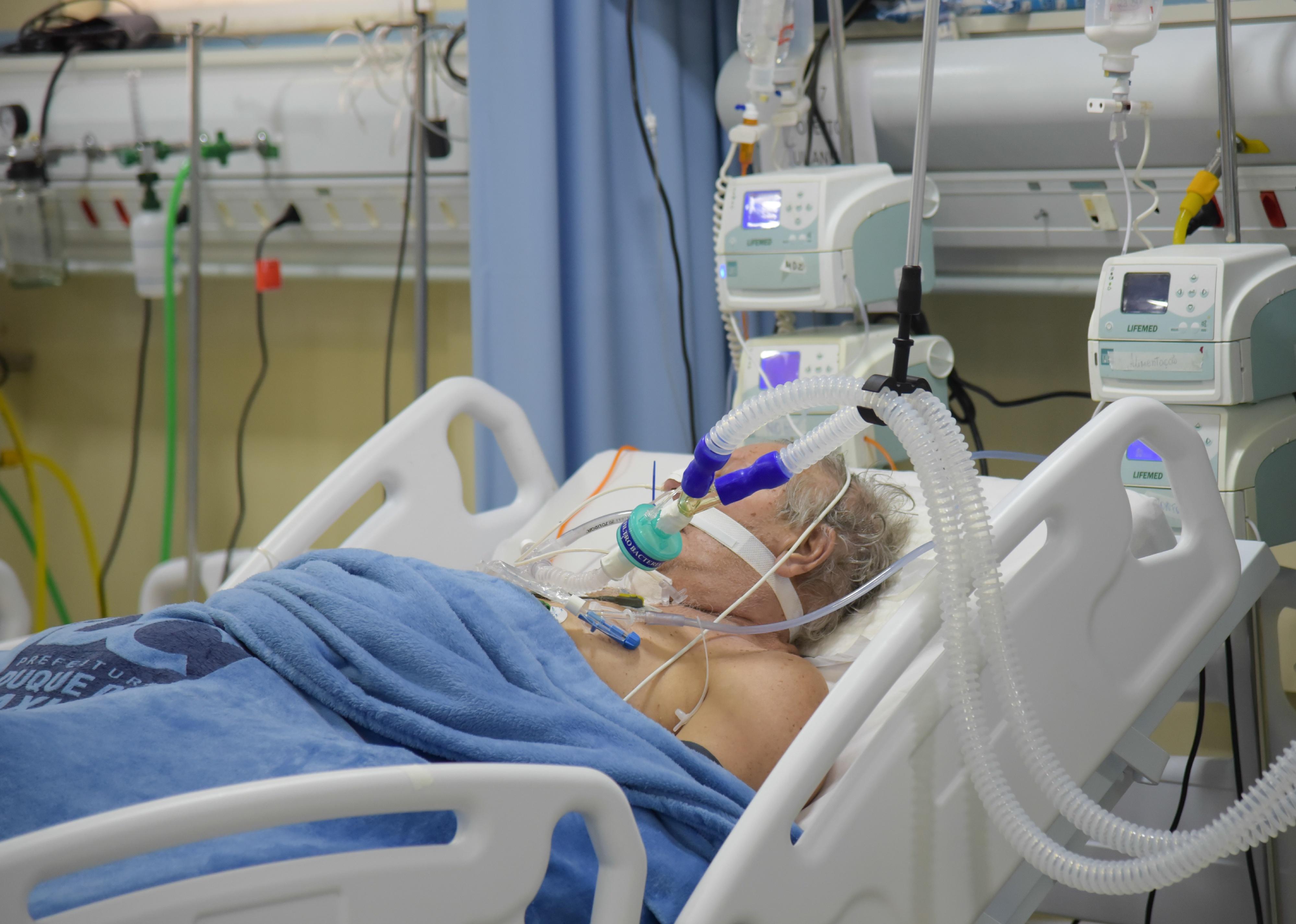 Sick man in hospital ICU bed.