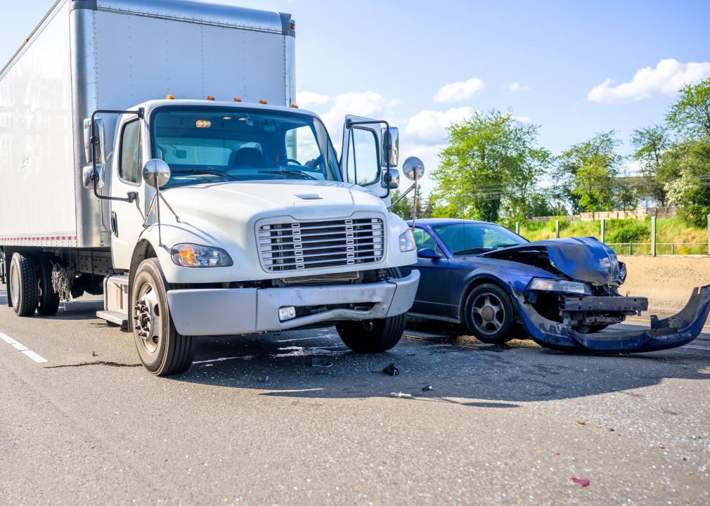Collision scene with a semi truck with box trailer and a passenger car