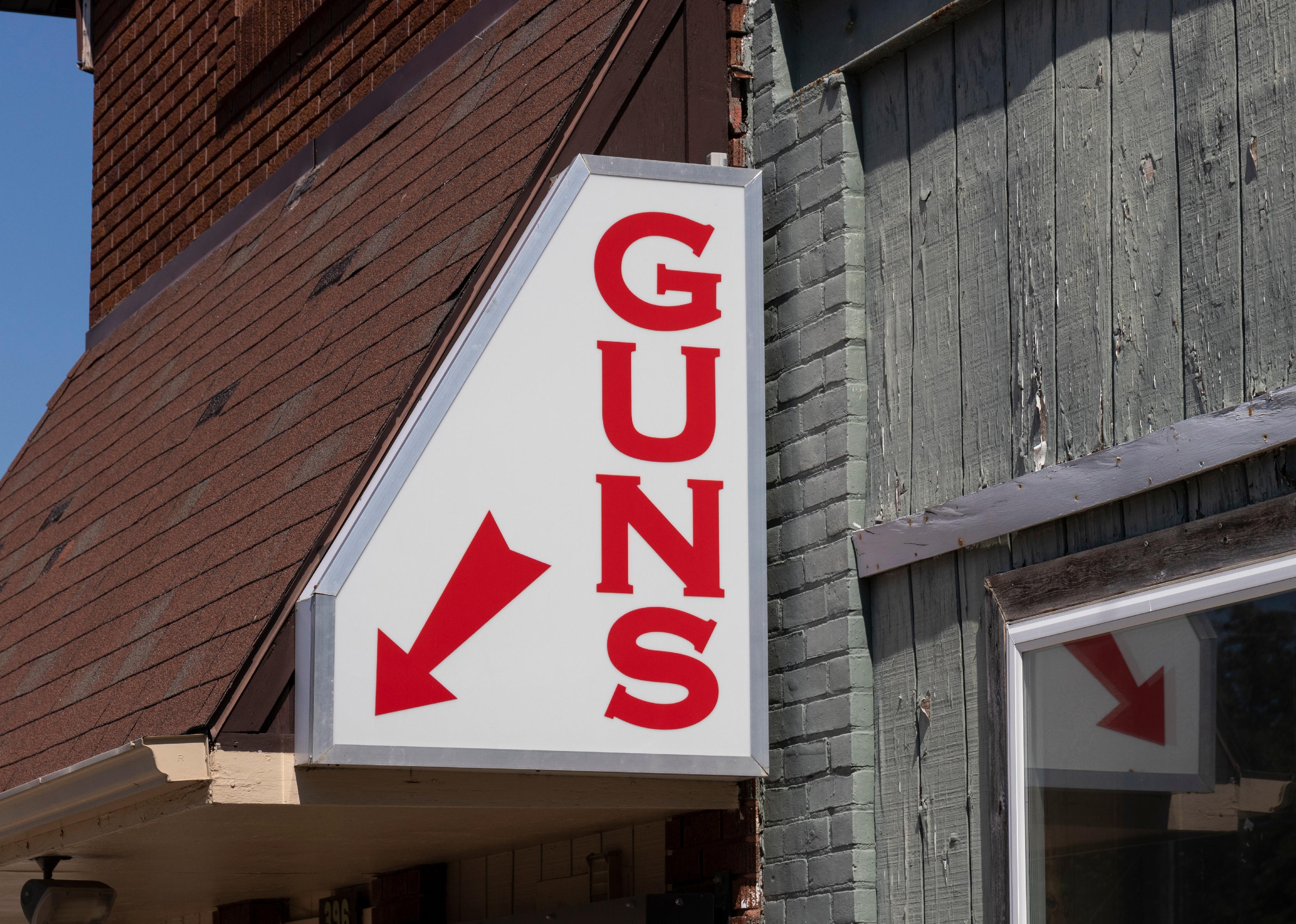Gun store sign on exterior of shop.