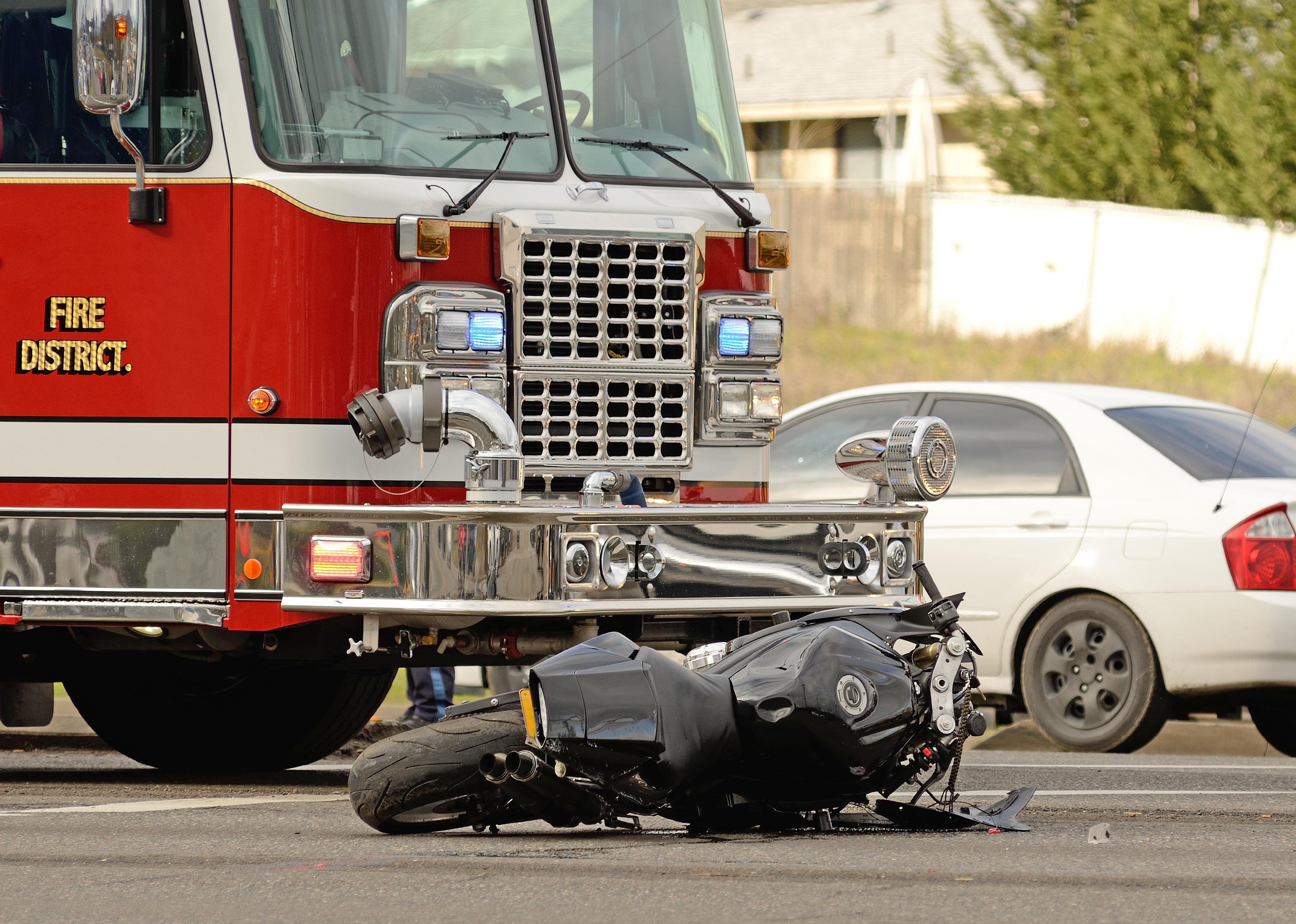 Emergency responders at the scene of a motorcycle and car accident.