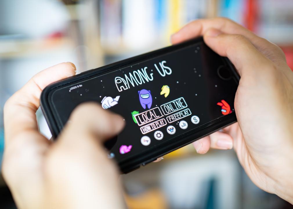 A gamer playing Among Us game on iPhone 7.
