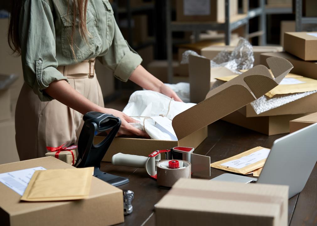 Closeup of female online store owner preparing a package