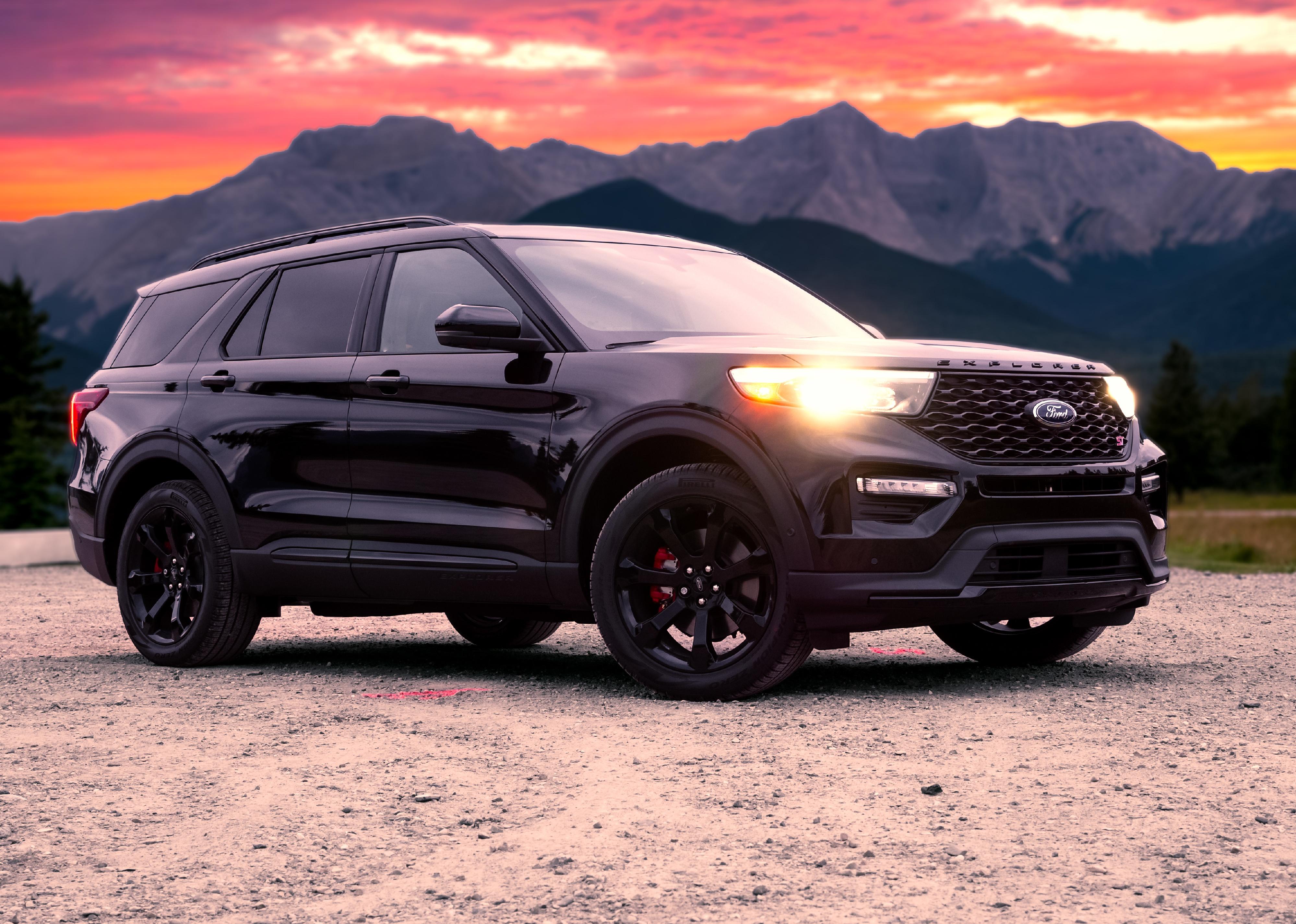 A 2020 Ford Explorer in front of mountains during a sunset.