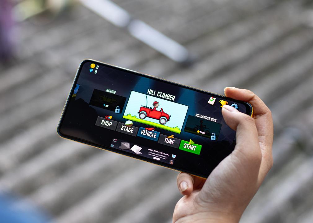 Hill Climb Racing game shown on a phone.