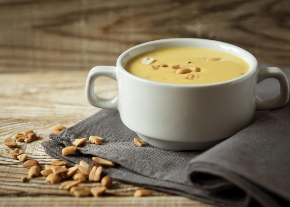 Mashed peanut soup with coconut milk in a white plate.