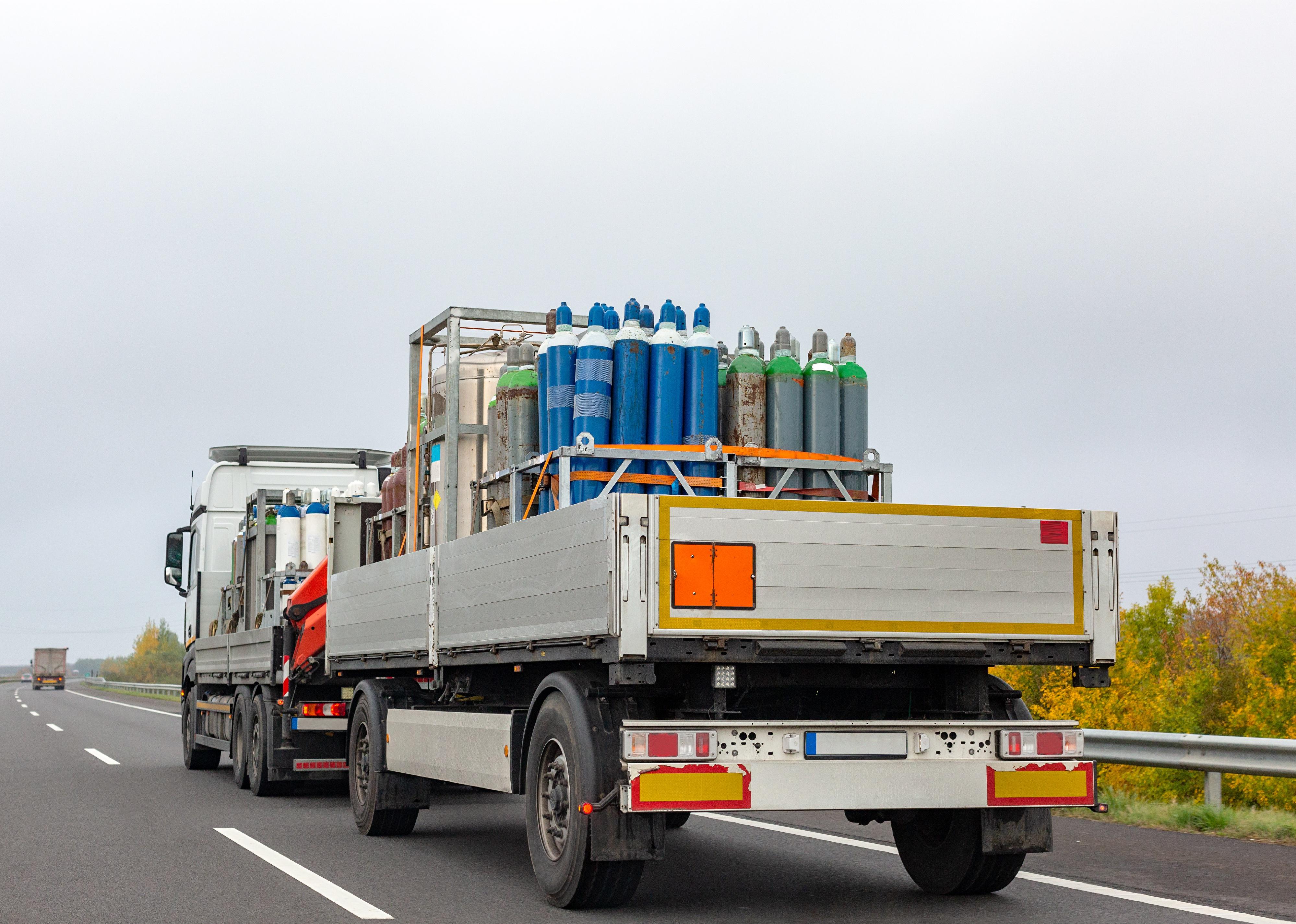 Truck delivering gas cylinders for medical purposes.