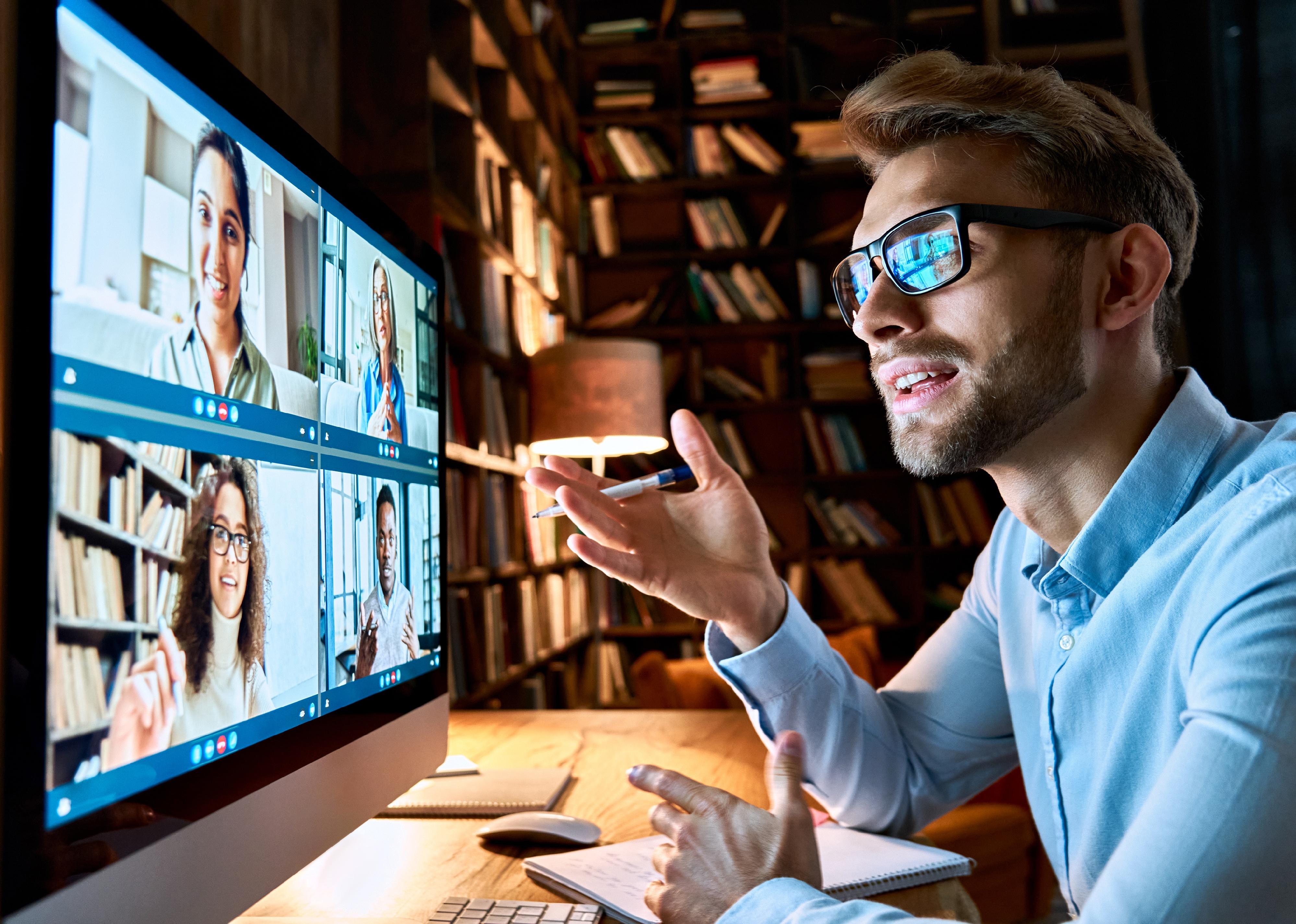 Young business man talking with colleagues on video conference