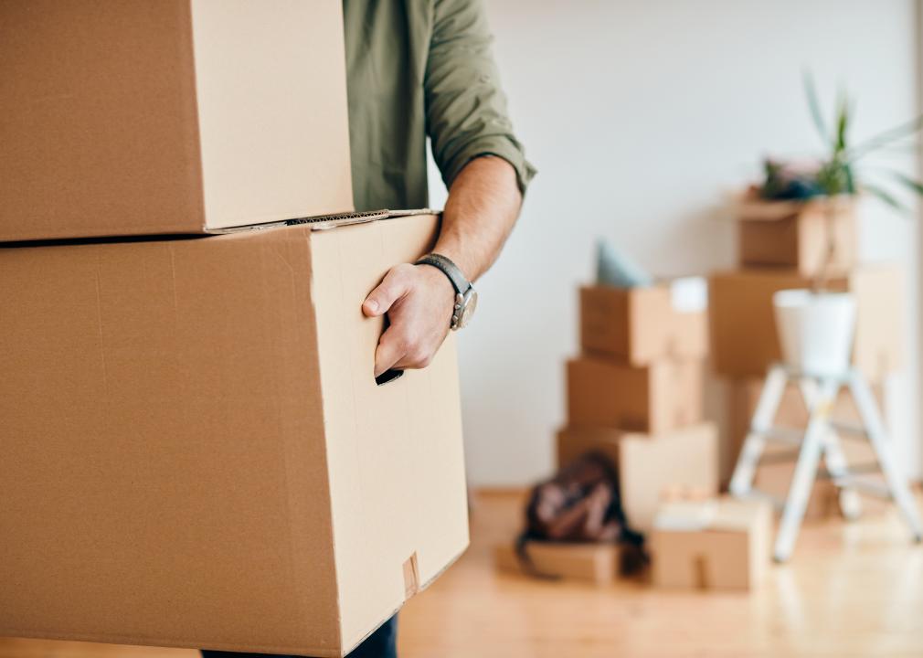 Close-up of a man carrying cardboard box