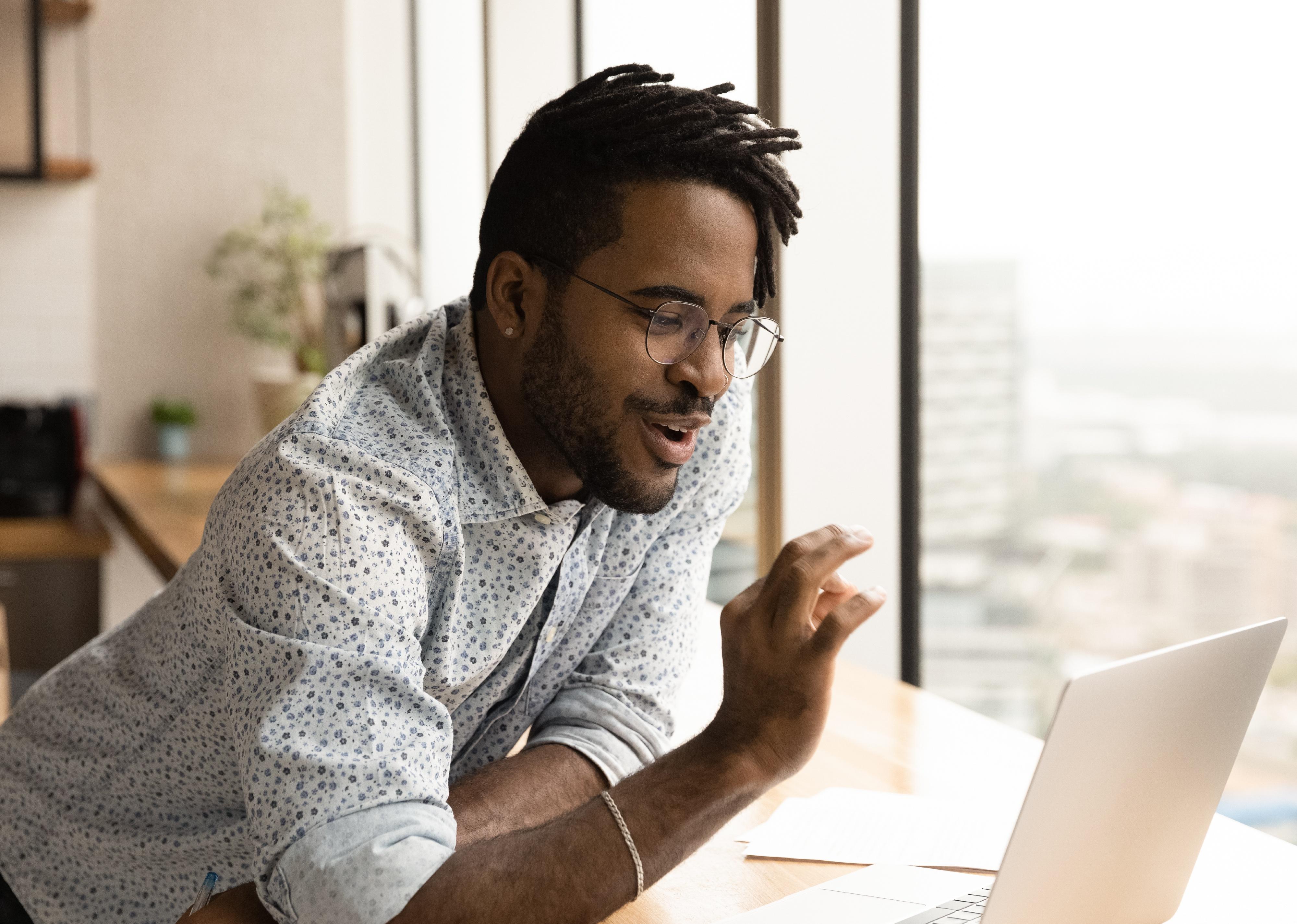 Man speaking towards video call on laptop