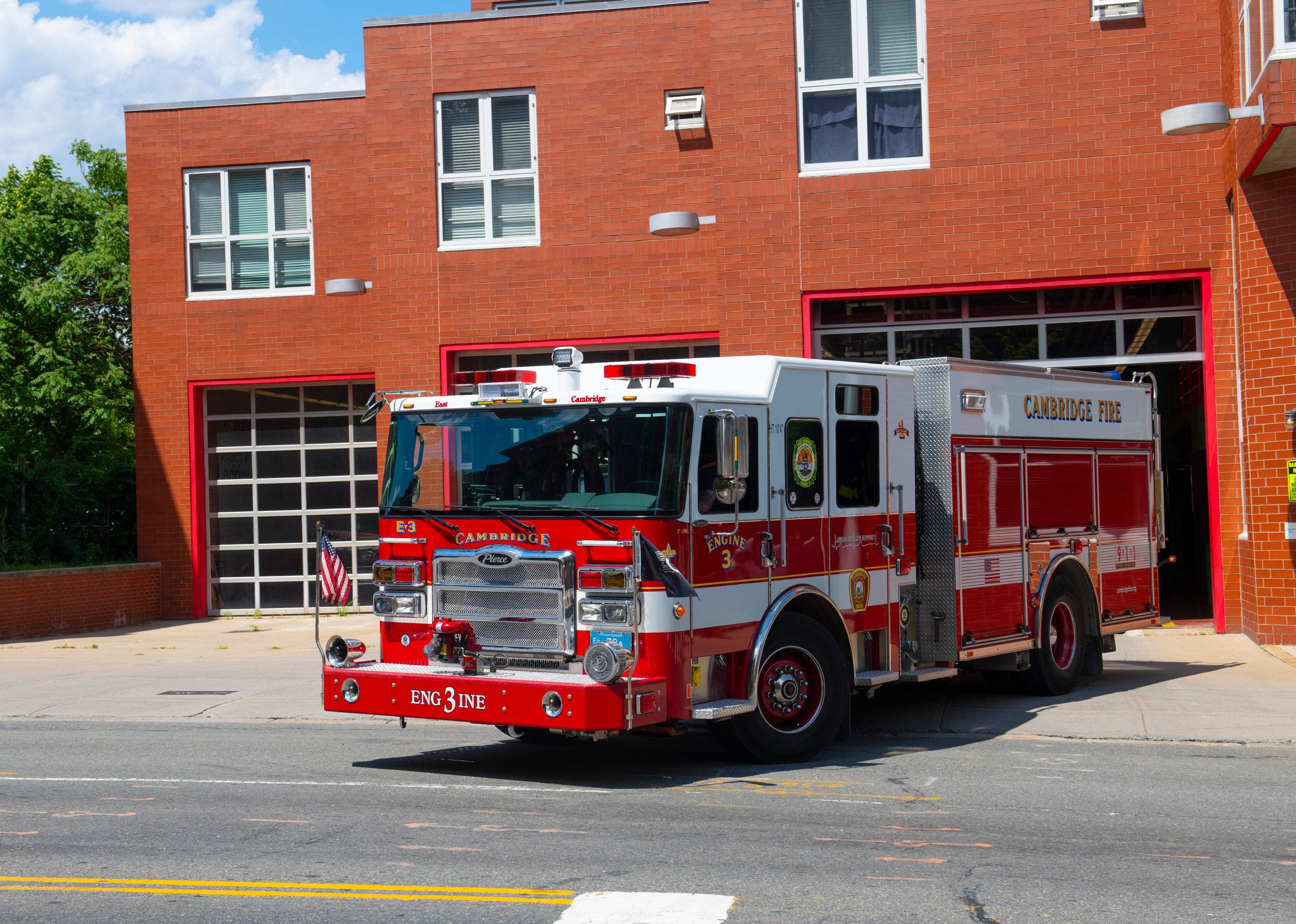 Fire truck pulling out of fire station.