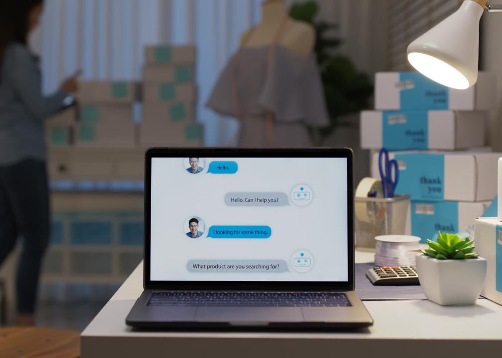 Chatbot conversation on laptop screen with artificial intelligence providing customer support.