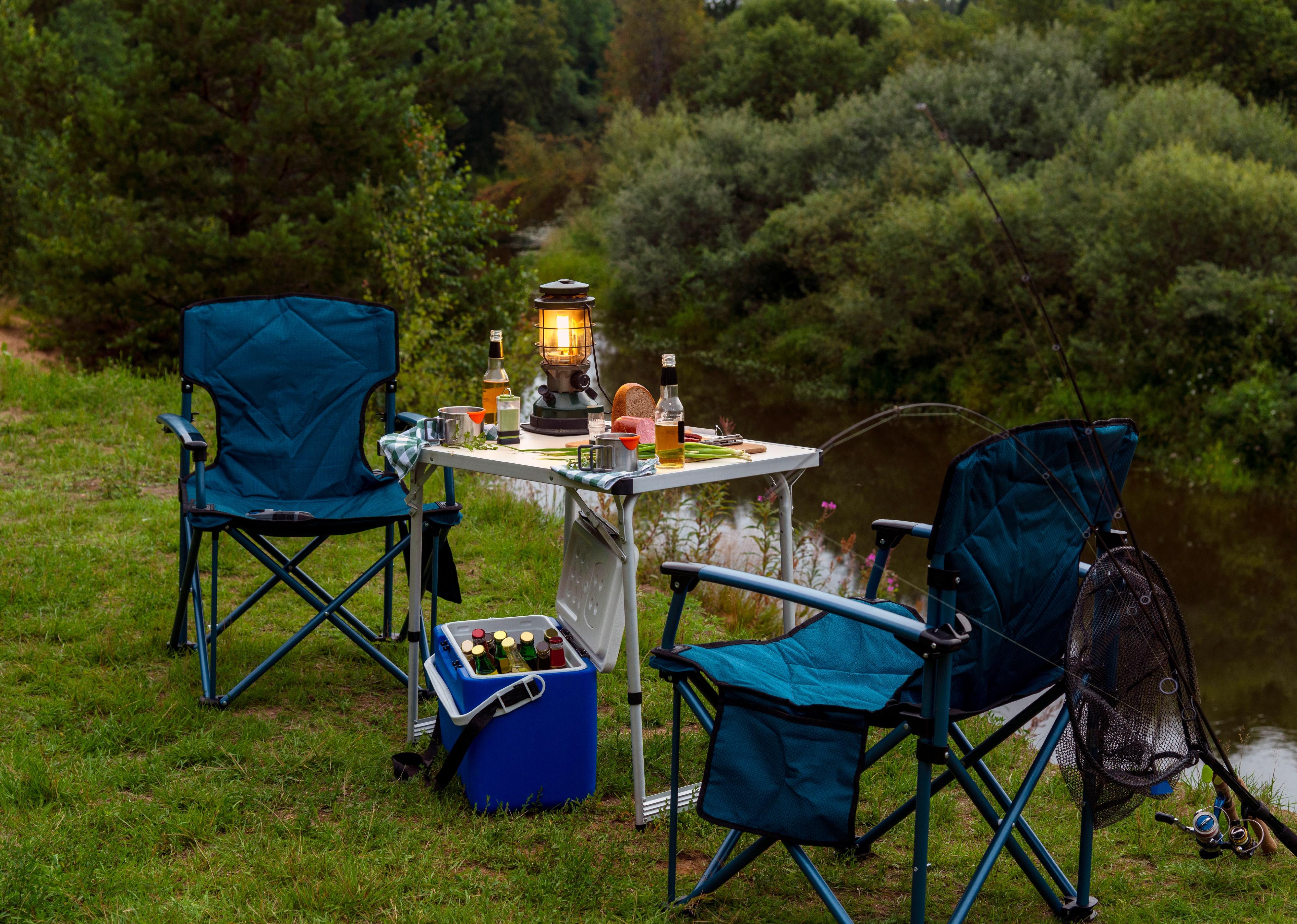 Folding chairs and table set up on grass