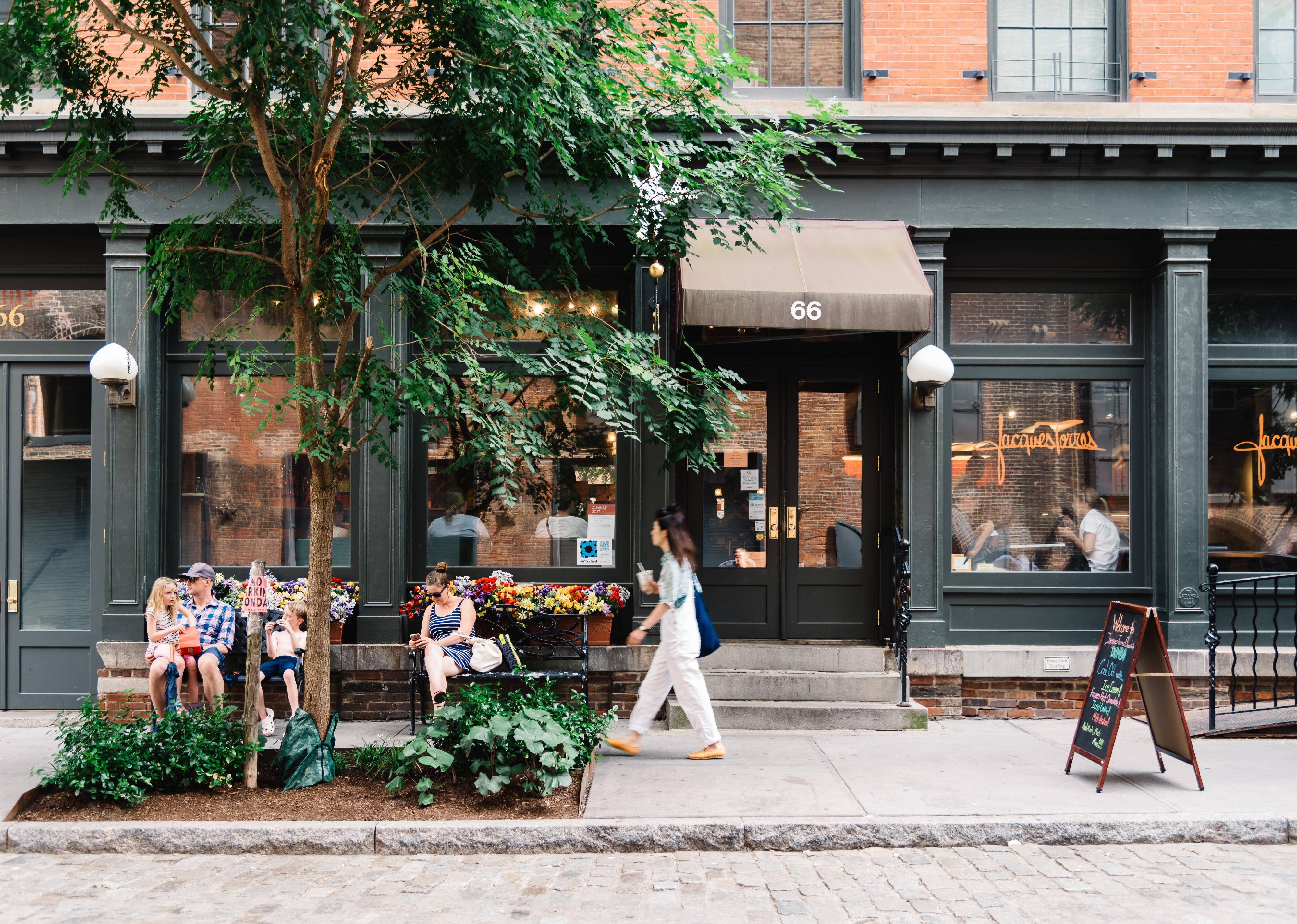 People sitting outside a trendy hipster cafe.