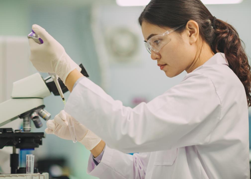 A lab technologist doing pipetting research with blood samples.