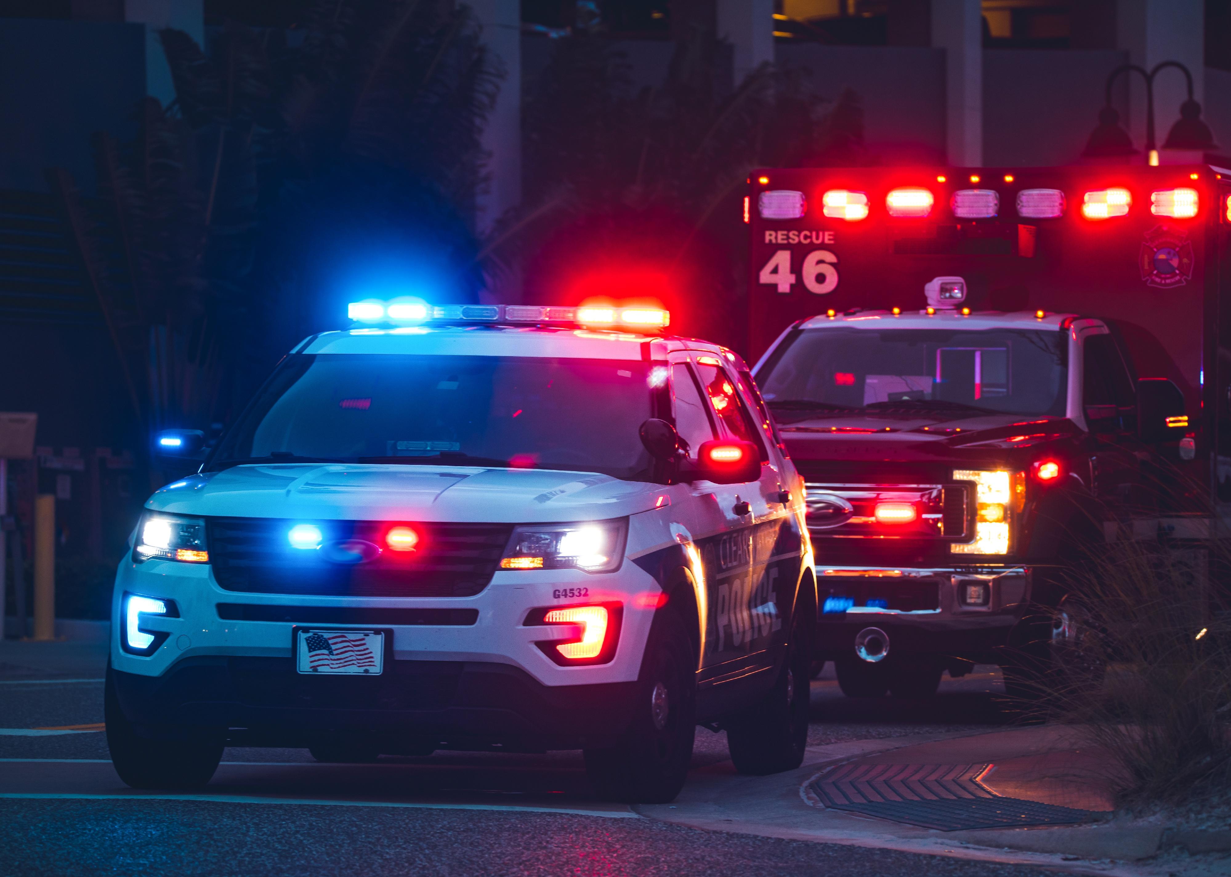 American Police Car and Emergency truck with blue and red lights.
