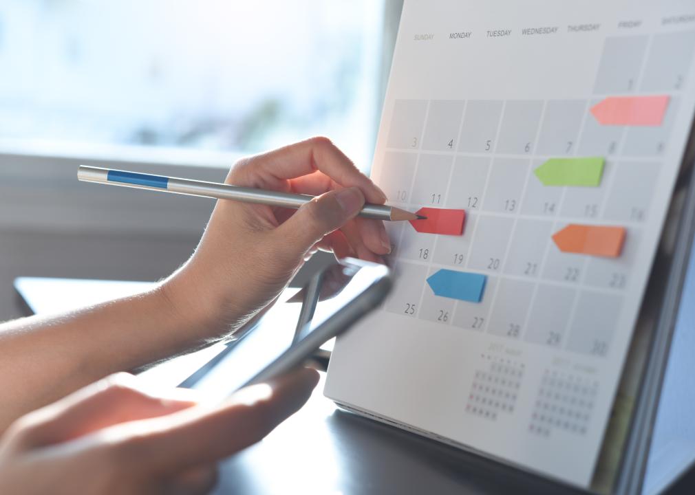 An employee marks a calendar with sticky notes