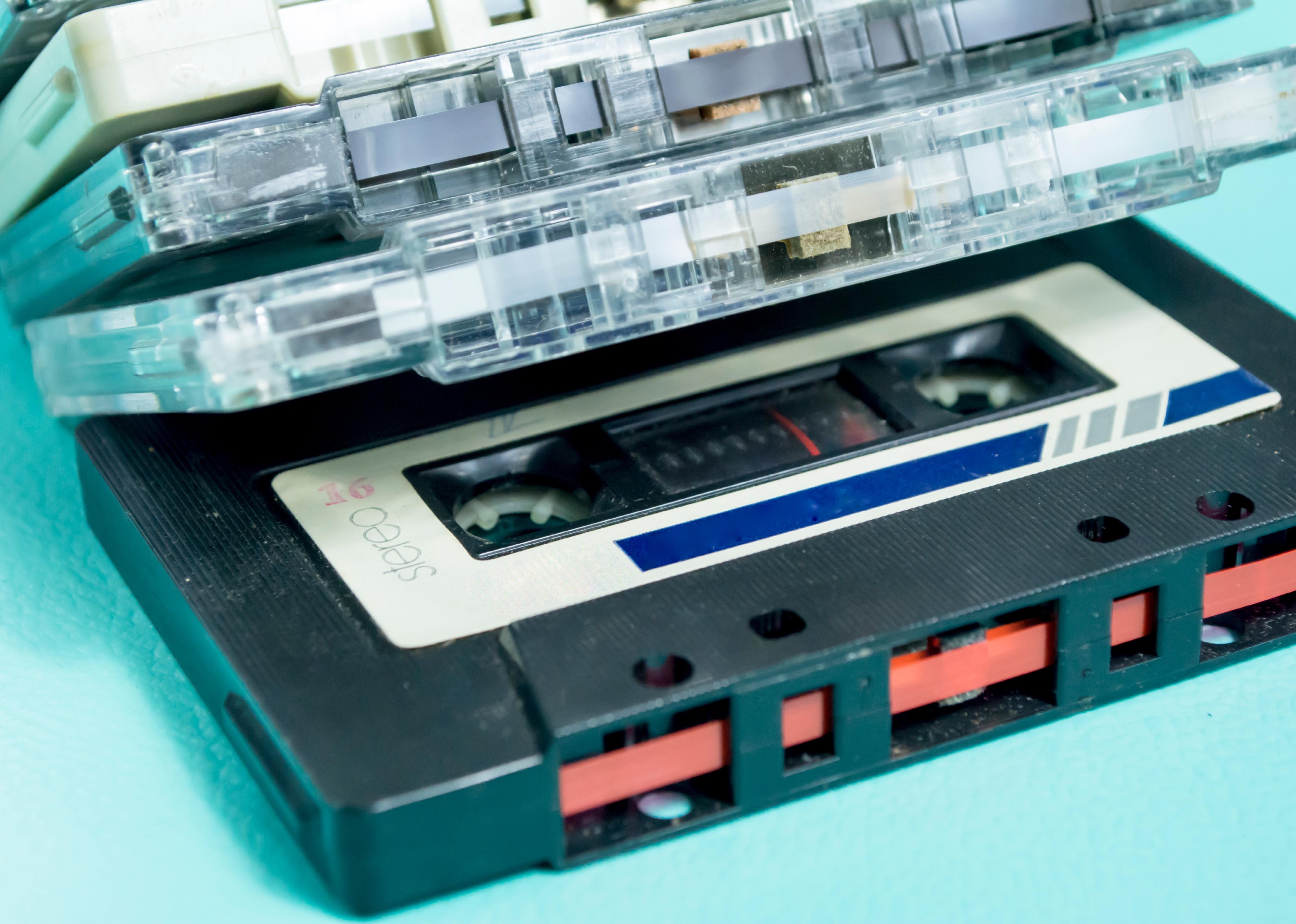 A black-colored cassette, voice sound storage, and magnetic tape.