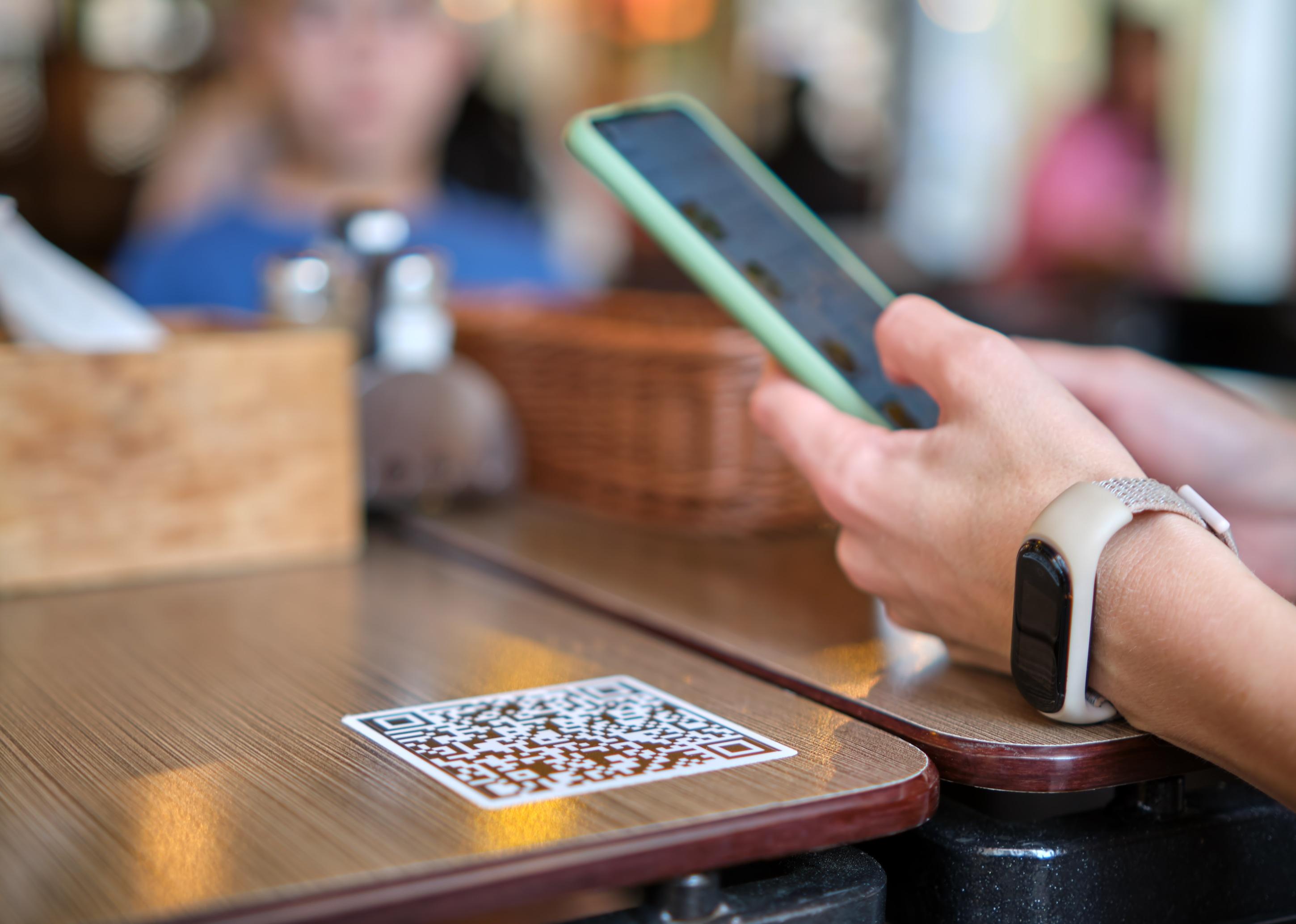 Closeup of guest scanning qr code with mobile phone