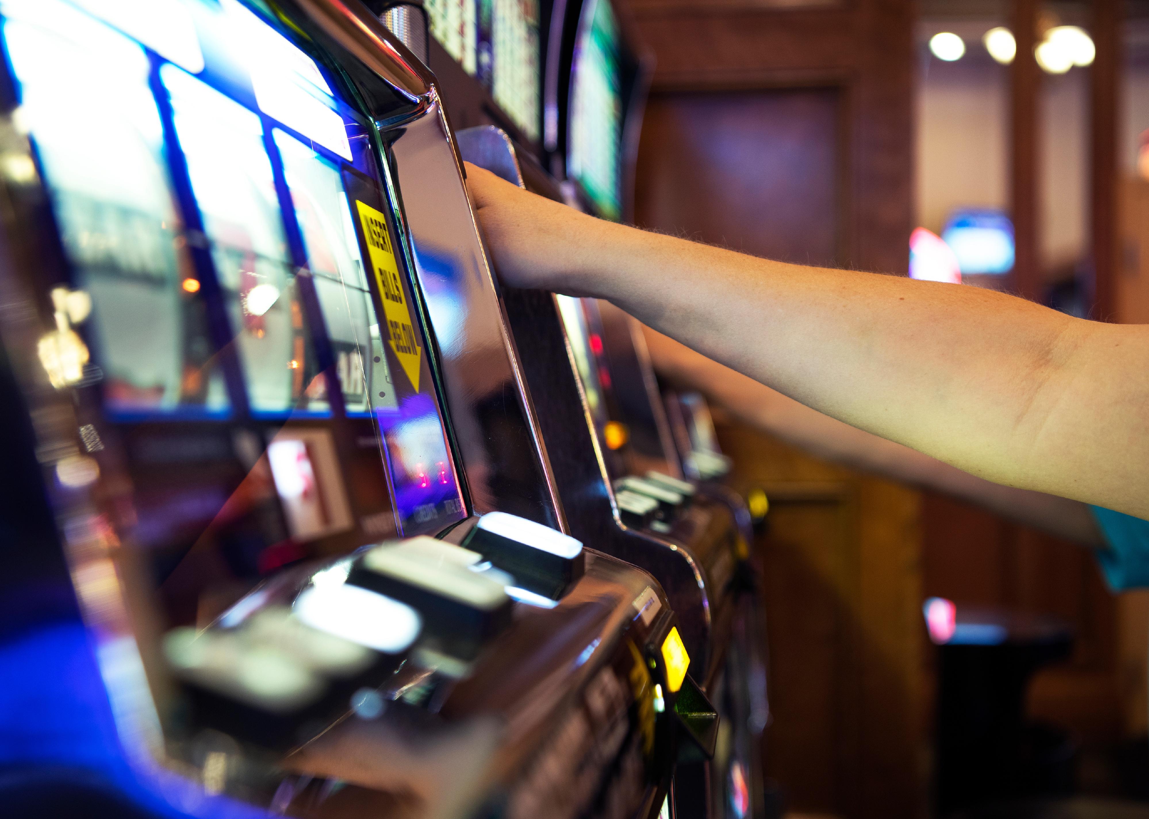 Close-up and side view of hands on slots.