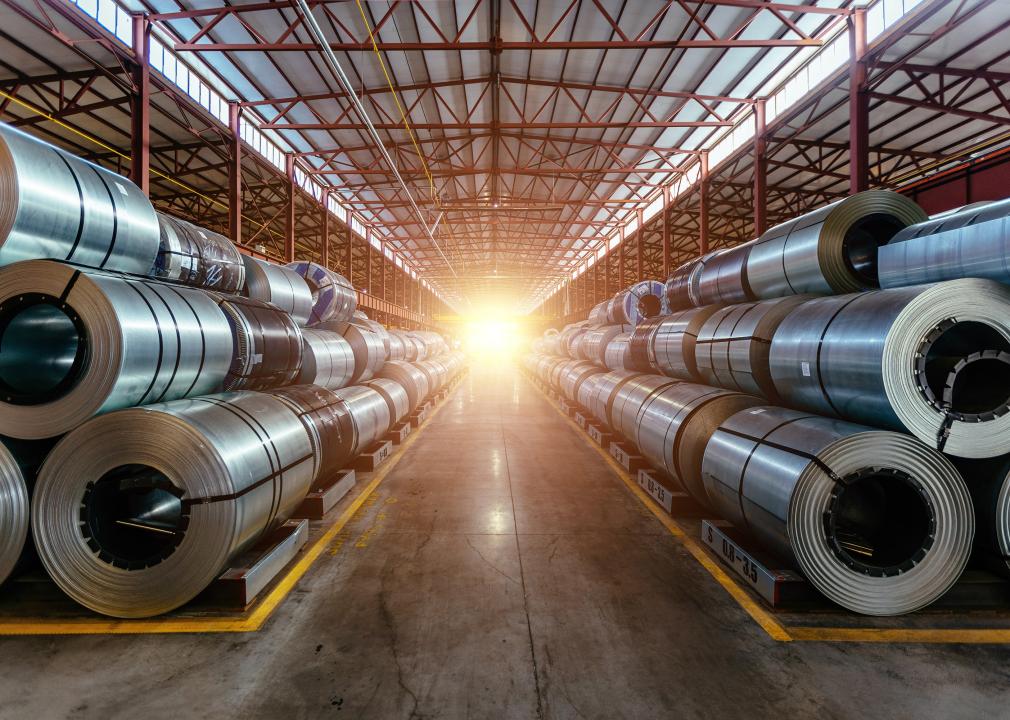 Rolls of galvanized steel sheet inside a factory.