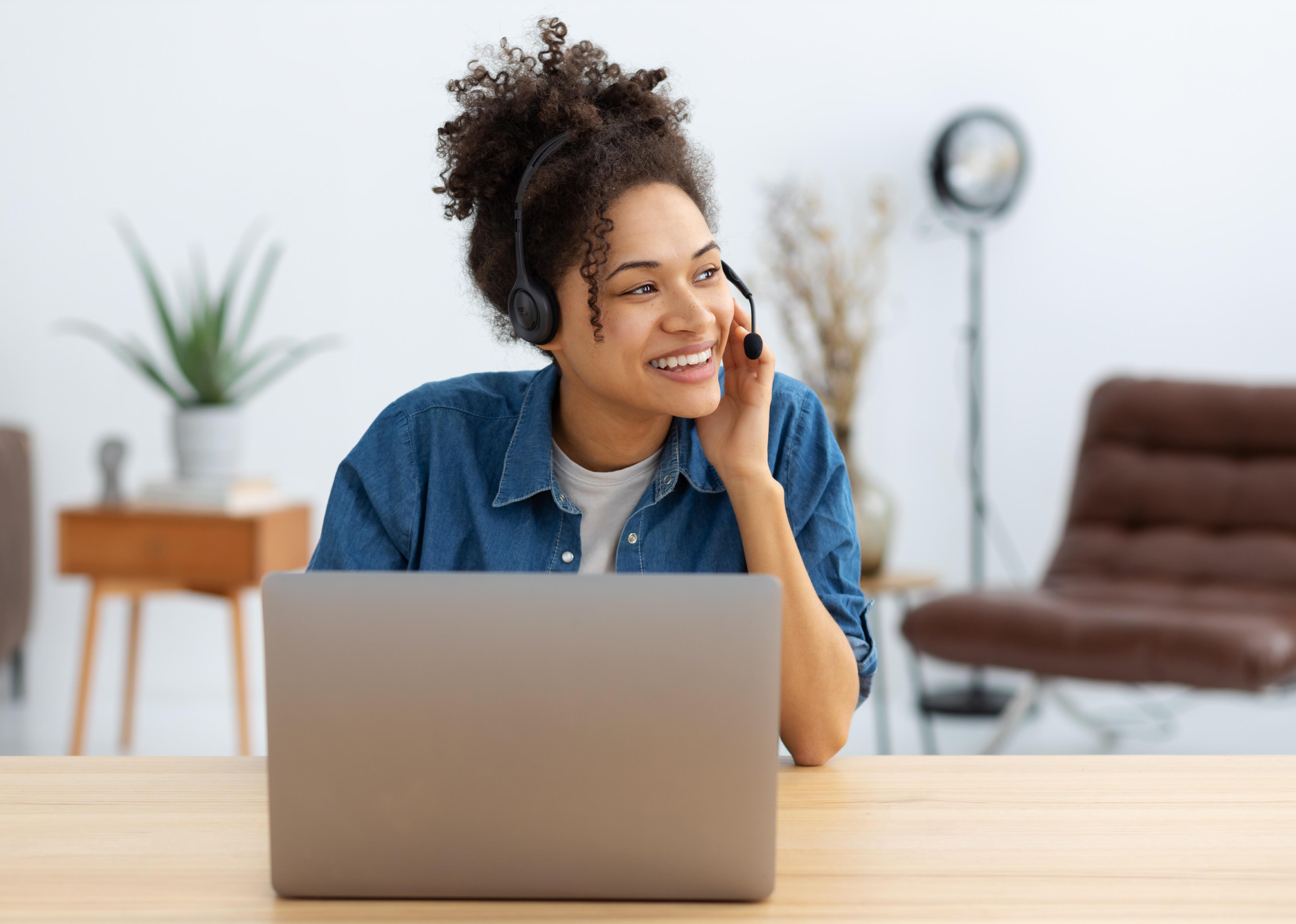 Happy female employee in headset on a call